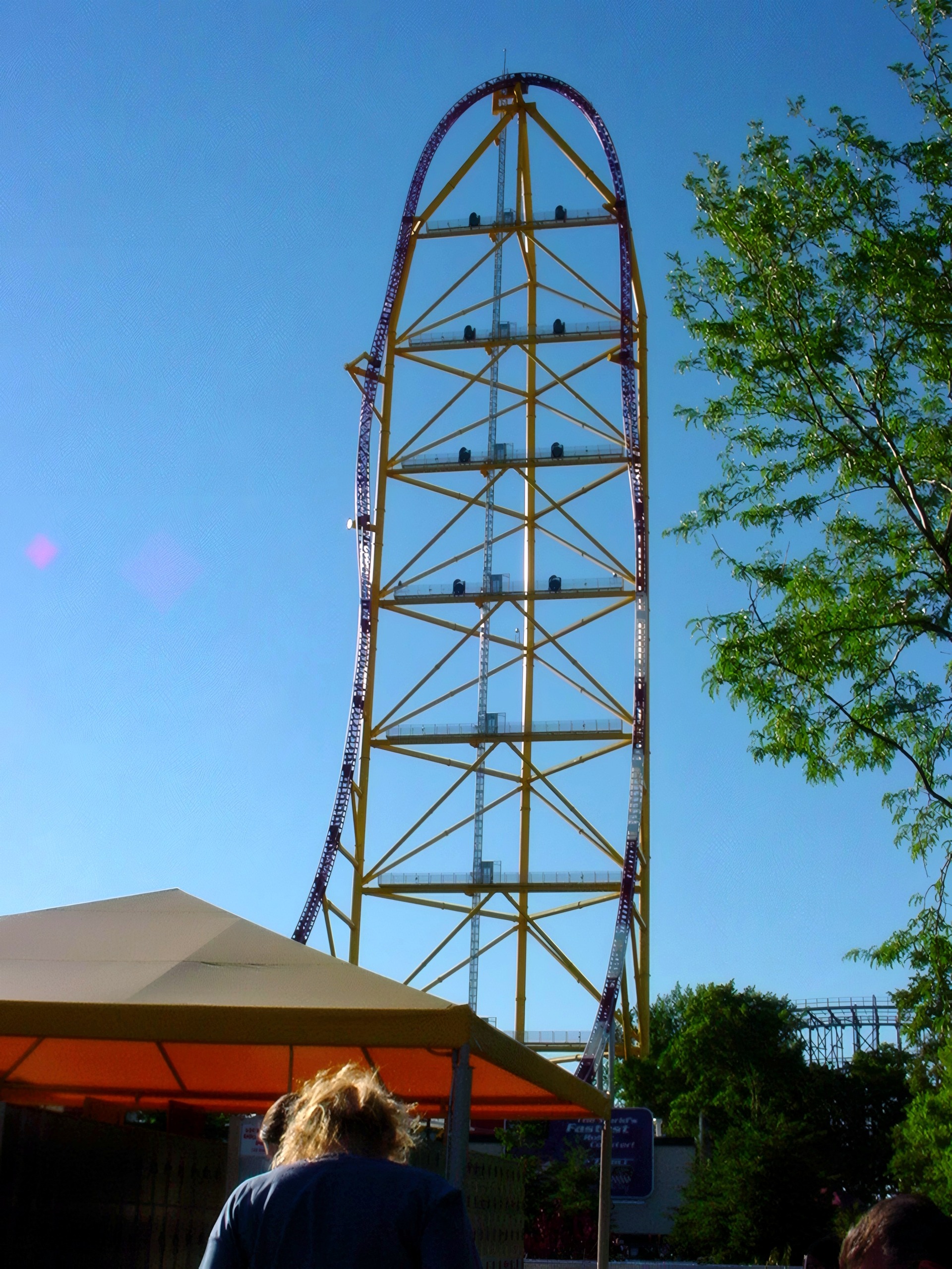 Tall coaster lift tower rising above trees, Top Thrill Dragster, July 2003