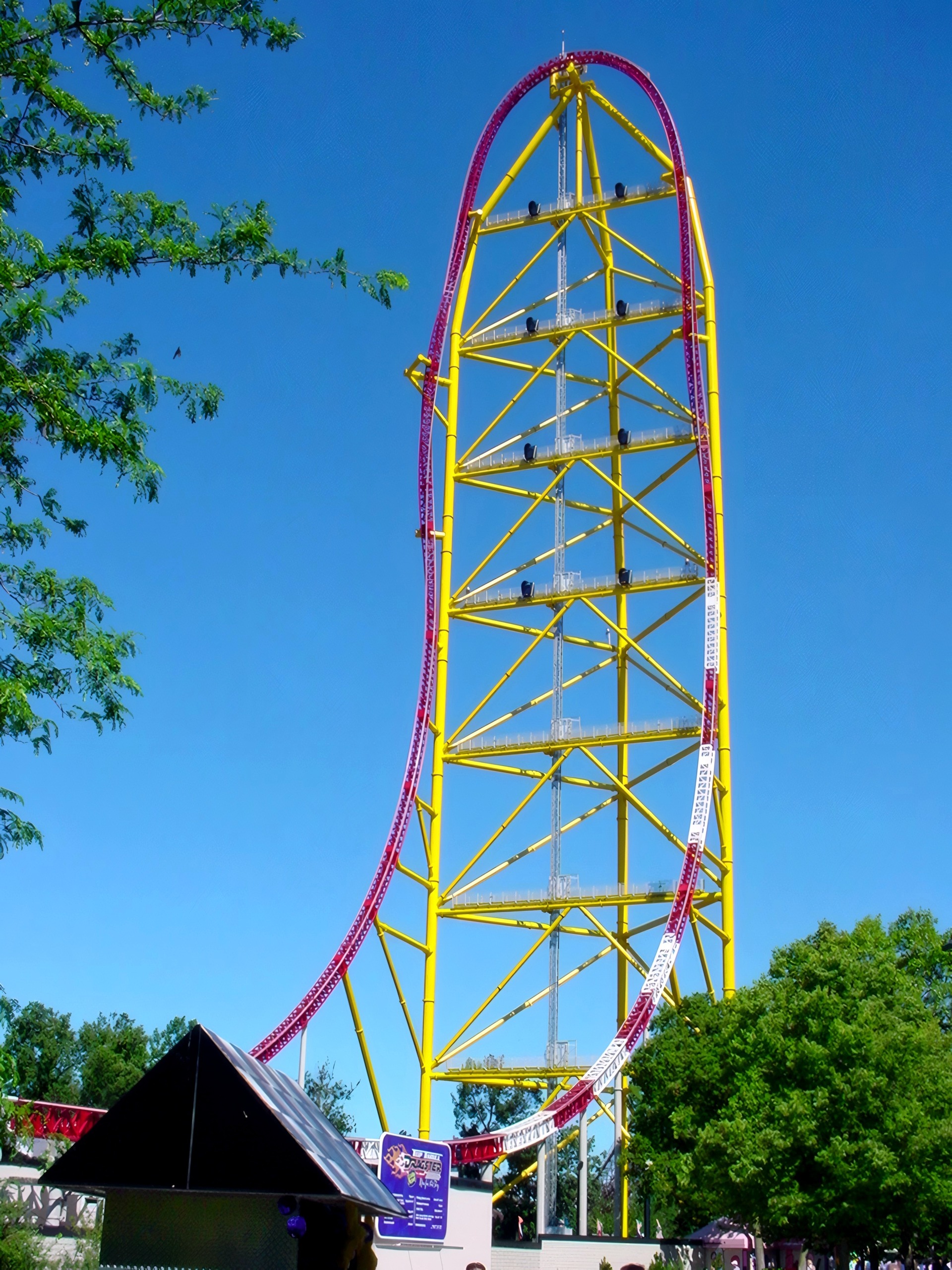 Yellow lattice tower with twisting red track, tent below, Top Thrill Dragster, July 2003