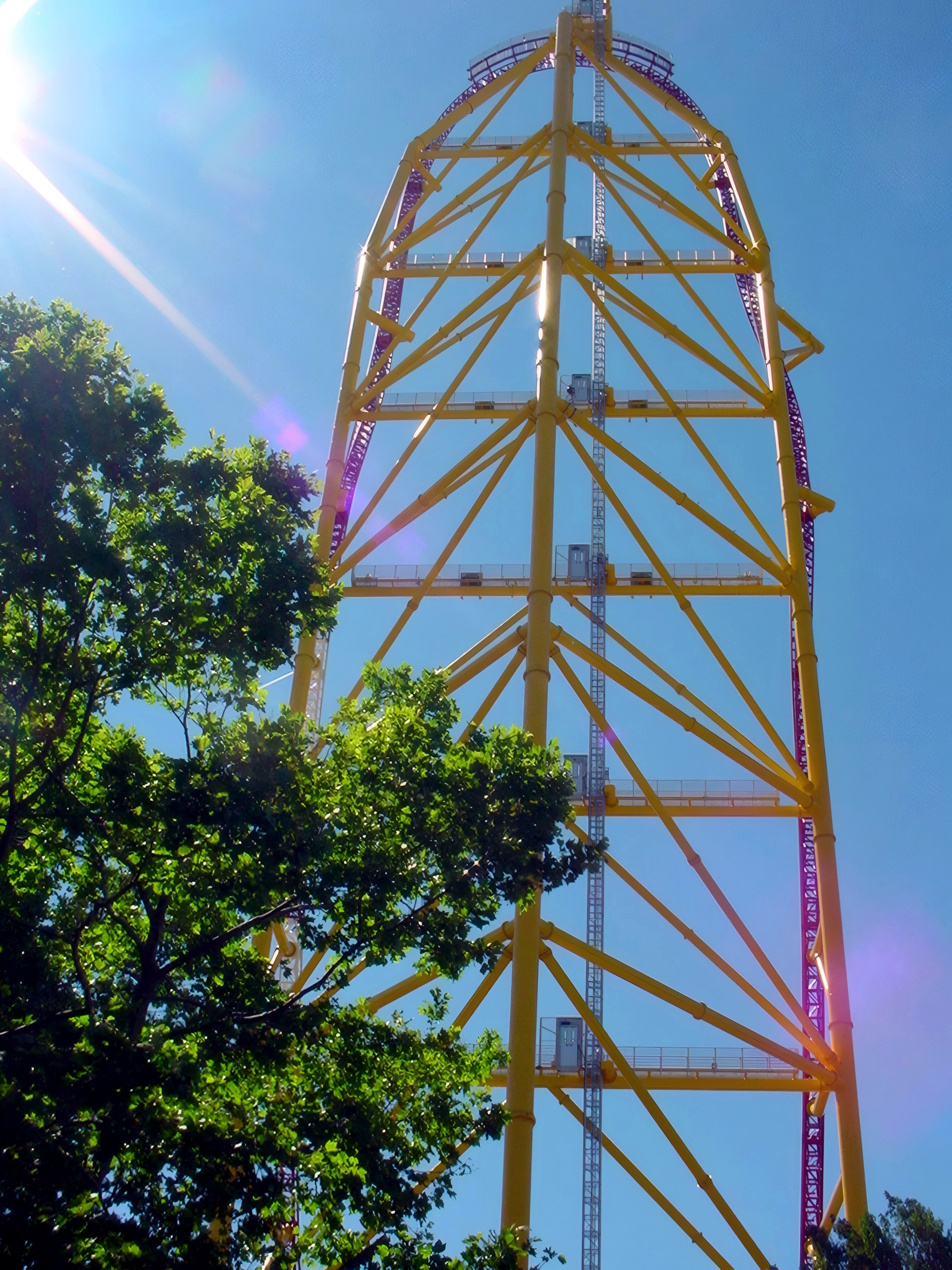 Yellow twisted launch tower against sky, sun flare, Top Thrill Dragster, July 2003