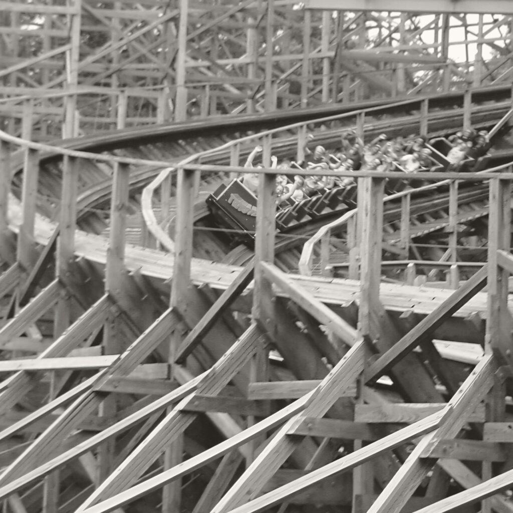 A Twister train banking through the wooden structure at Knoebels in a warm monochrome edit, July 2003