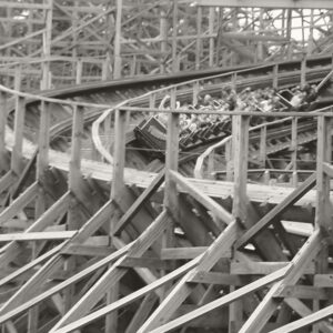 A Twister train banking through the wooden structure at Knoebels in a warm monochrome edit, July 2003