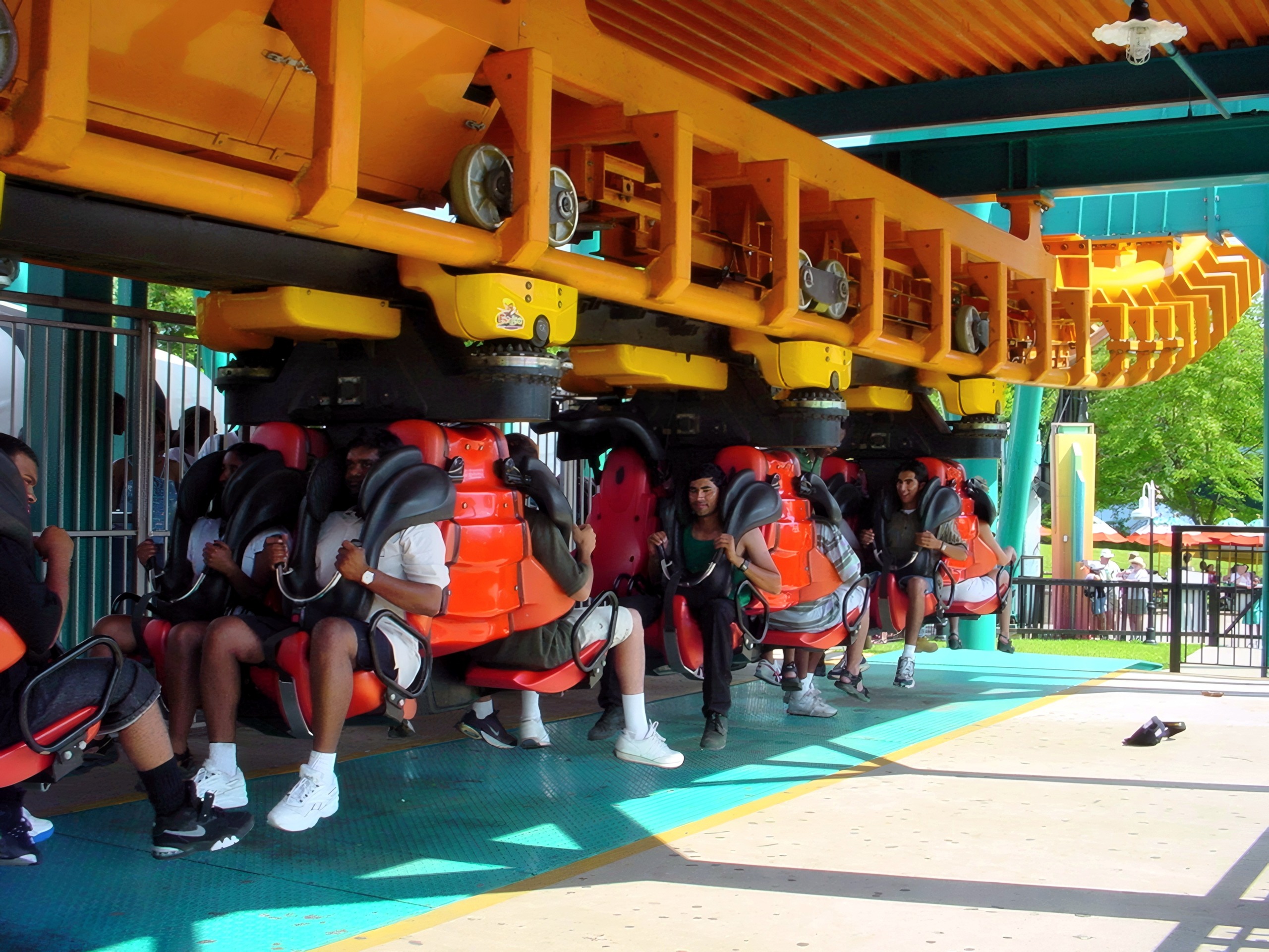 A Two-Face: The Flip Side train with riders seated face to face in the station at Six Flags America, July 2001