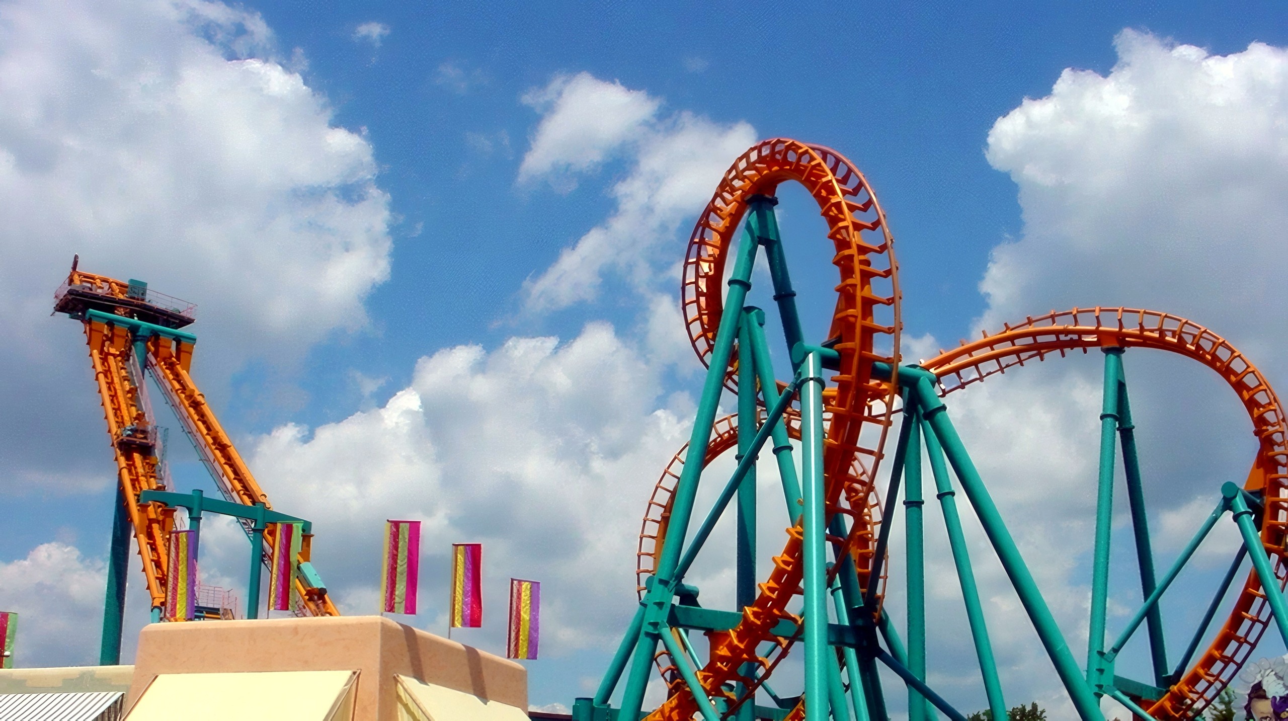 Two-Face: The Flip Side's lift tower and cobra roll above the midway buildings at Six Flags America, July 2001