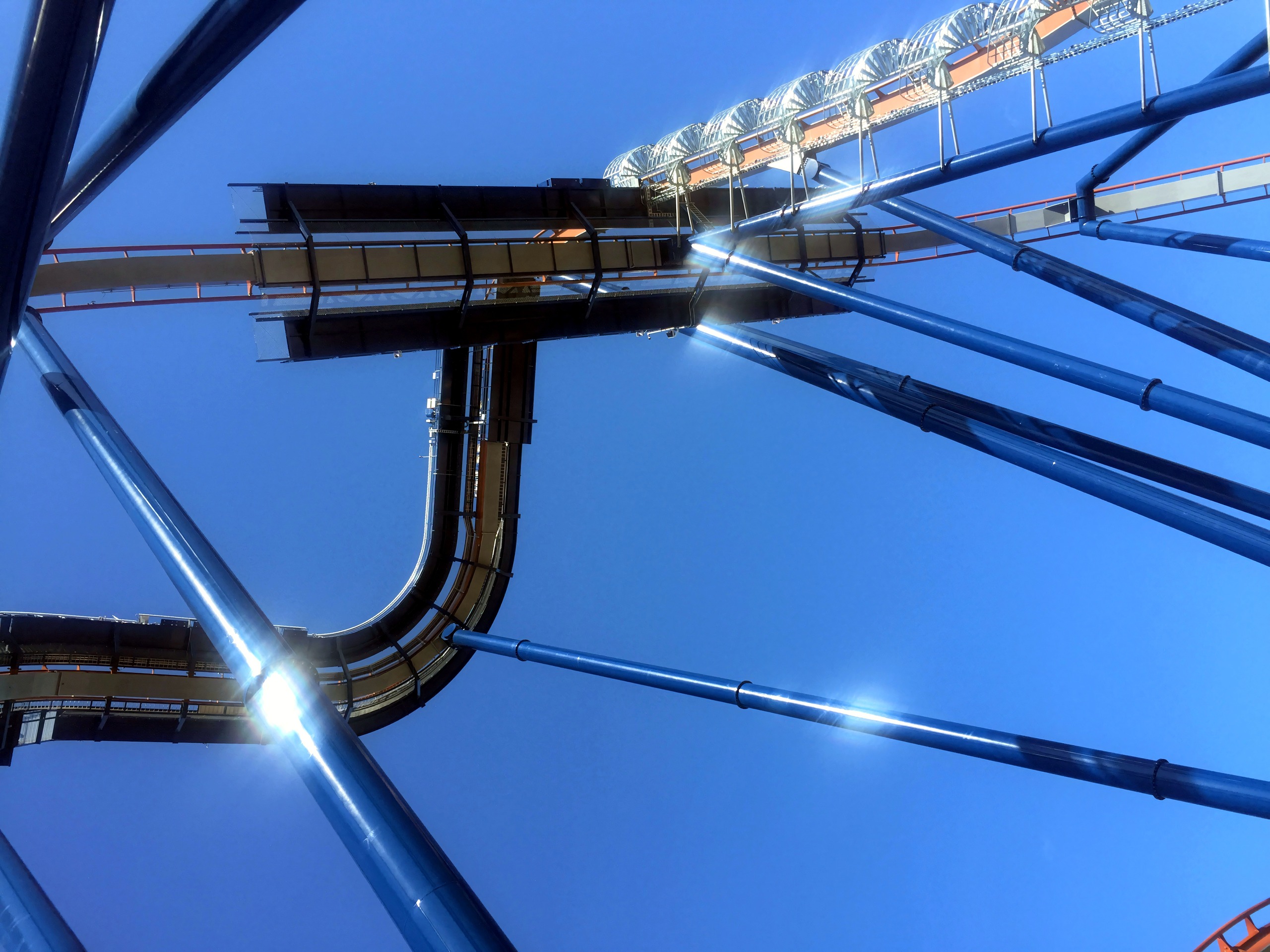 Close-up abstract view of blue coaster track crossing overhead, Valravn, July 2016
