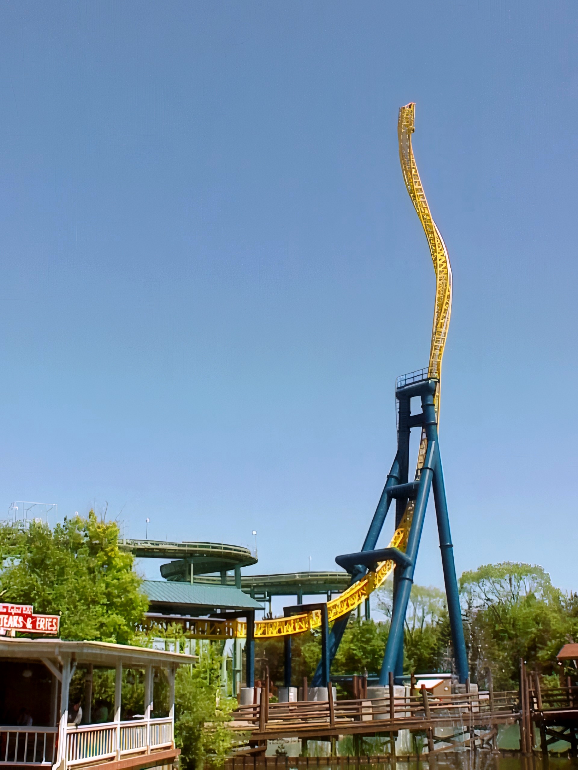 The Vertical Velocity twisted spike over the midway buildings at Six Flags Great America, May 2001