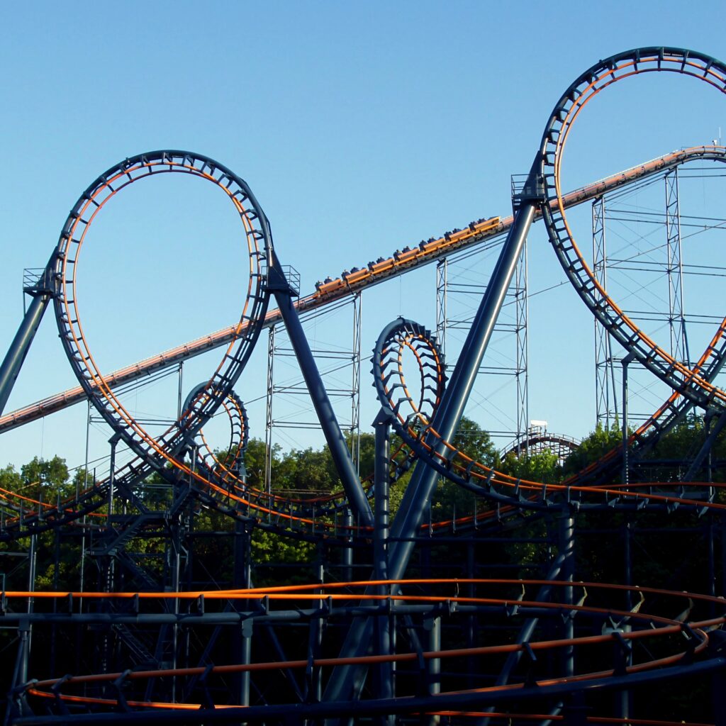 Vortex roller coaster at Kings Island with a train climbing the lift between its two vertical loops