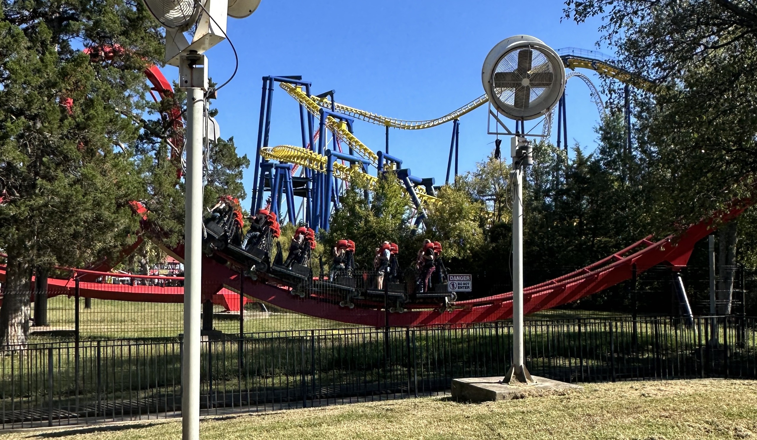 A Vortex train on the low red track with Nighthawk's yellow track behind, Carowinds, October 2024
