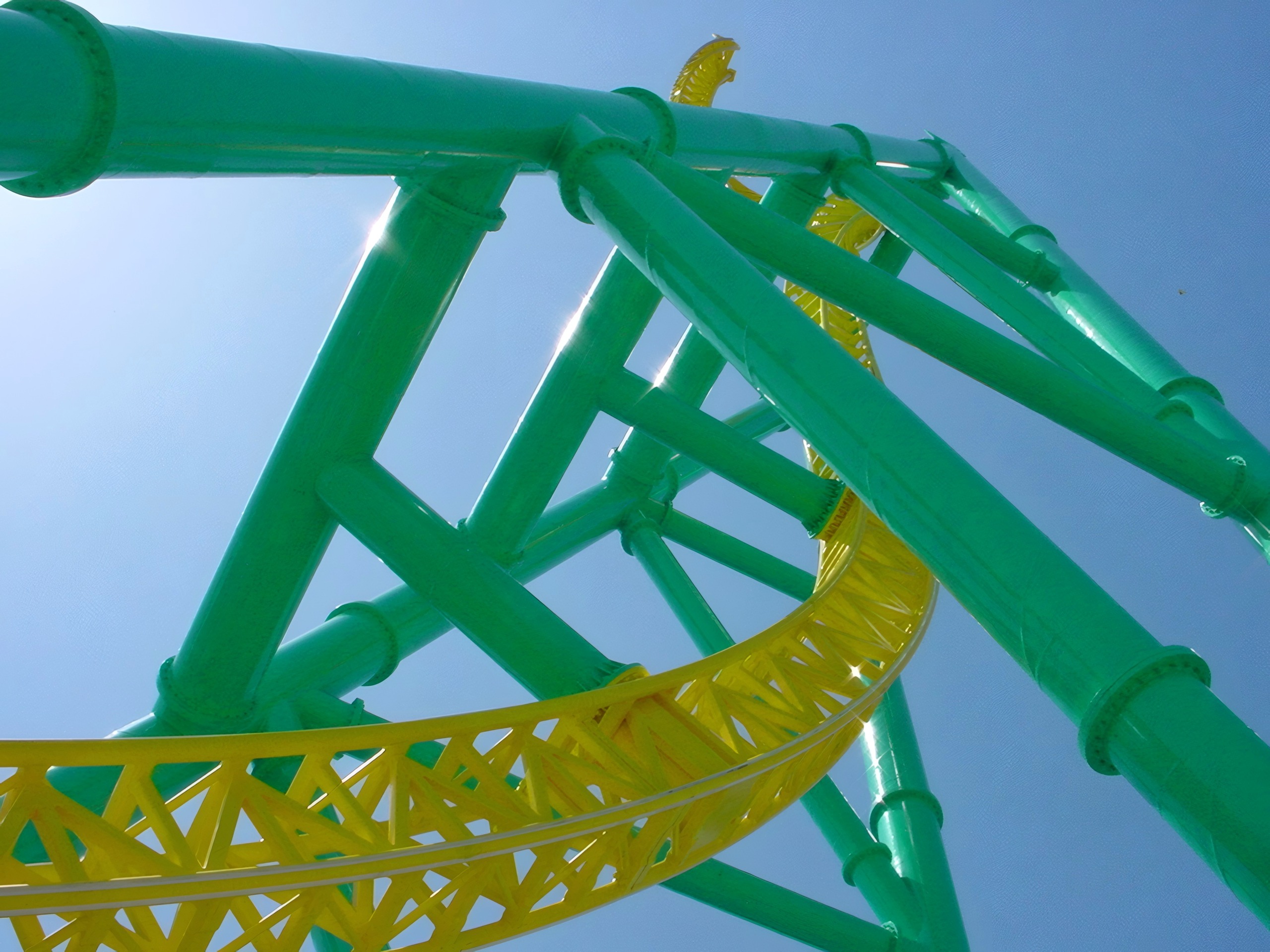 Close-up of green tower and yellow twisted track against sky, Wicked Twister, May 2002