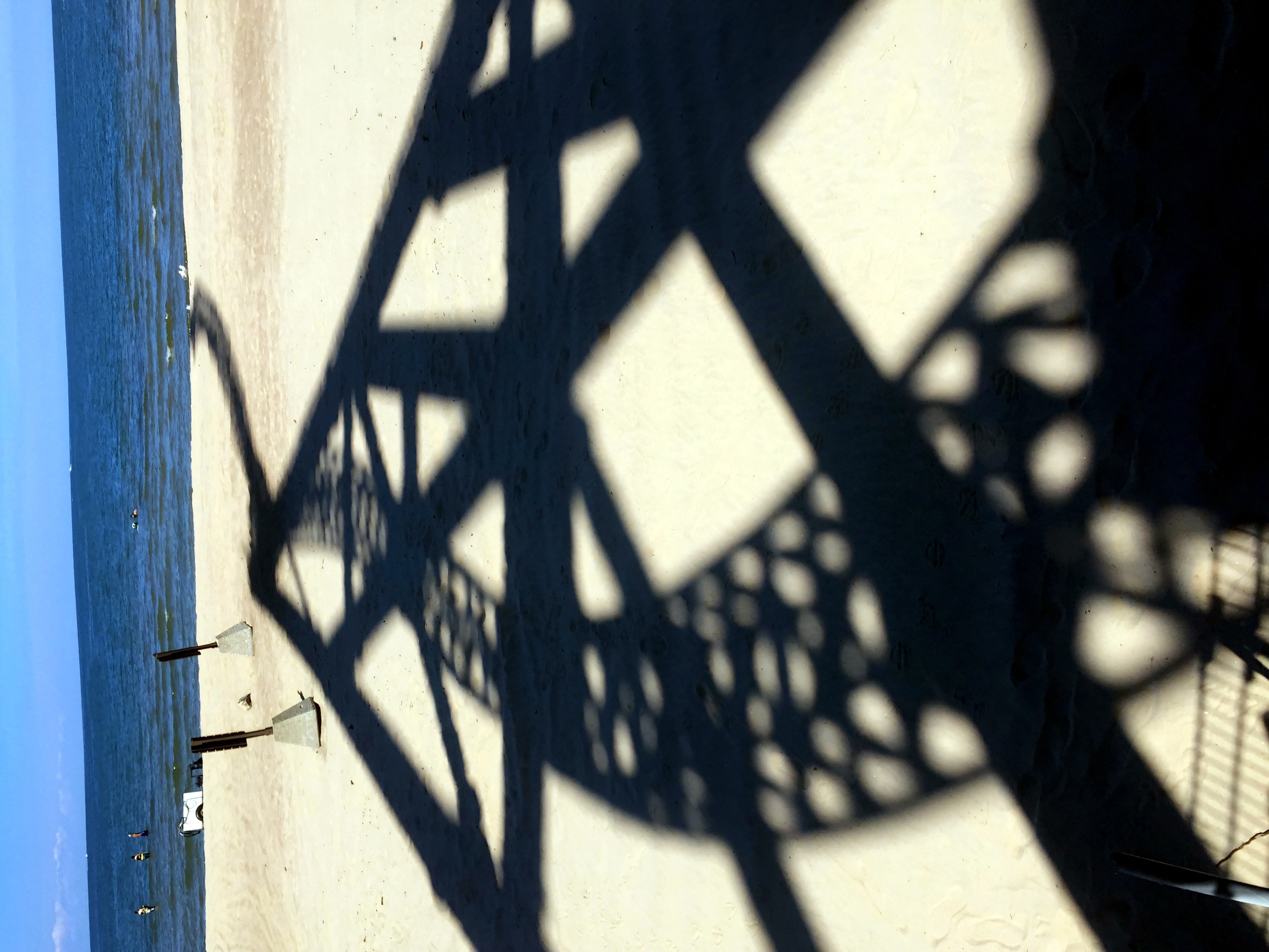 Coaster structure shadow on sandy beach, lake horizon, Wicked Twister, July 2016