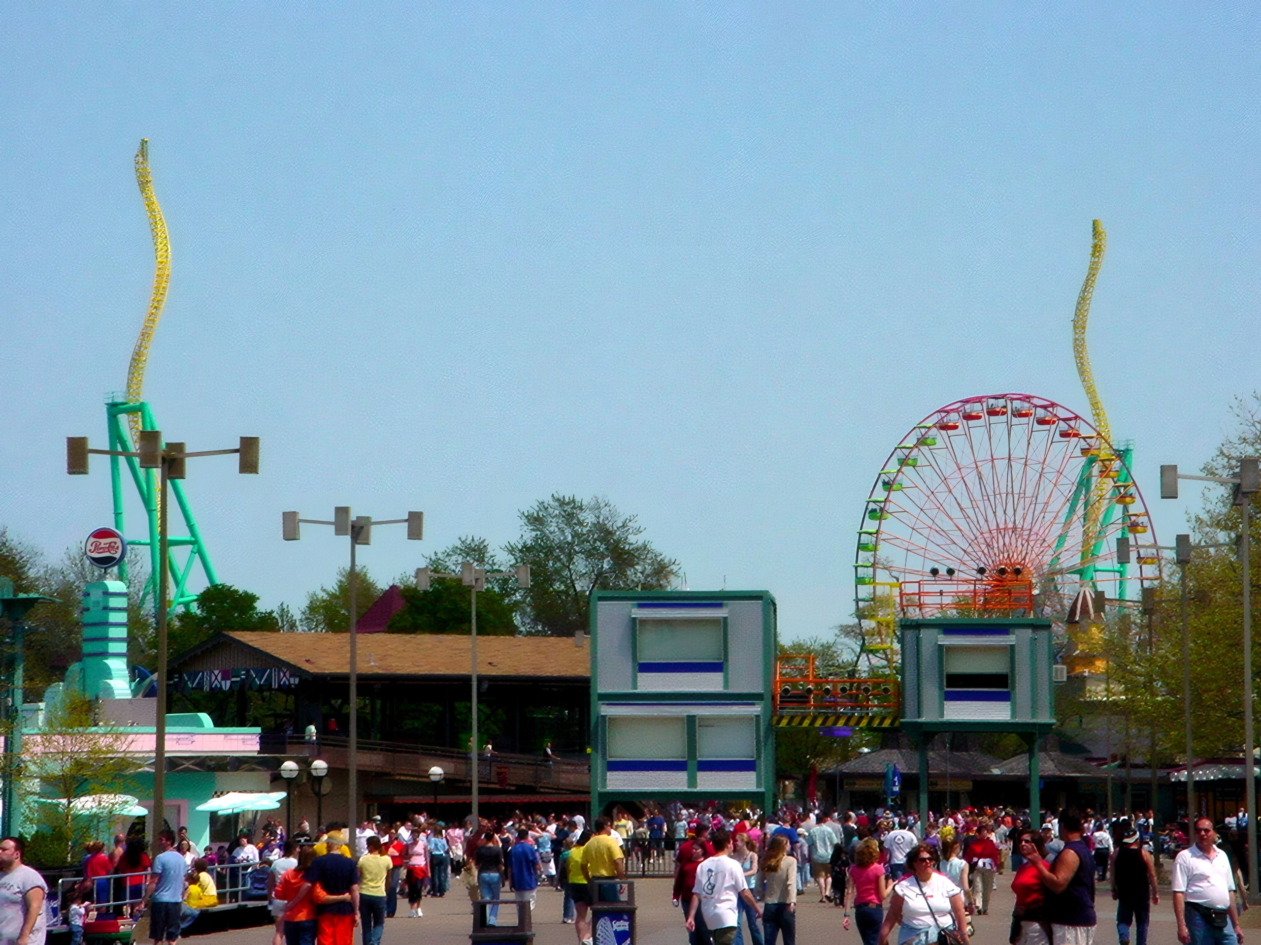 Midway view with ferris wheel, towers, and crowds, Wicked Twister, May 2002