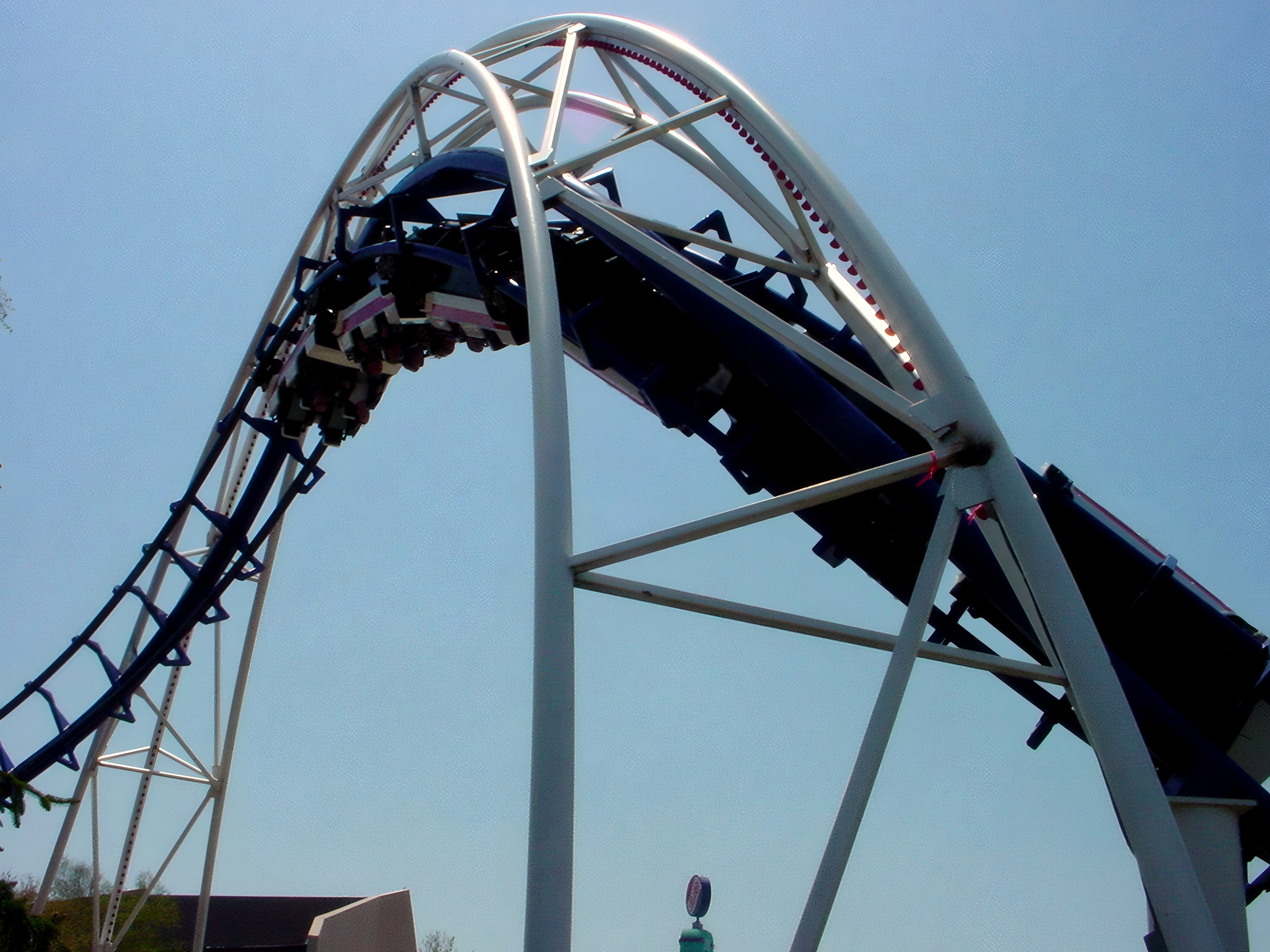 Train cresting twisted spike tower with dangling-leg seats, Wicked Twister