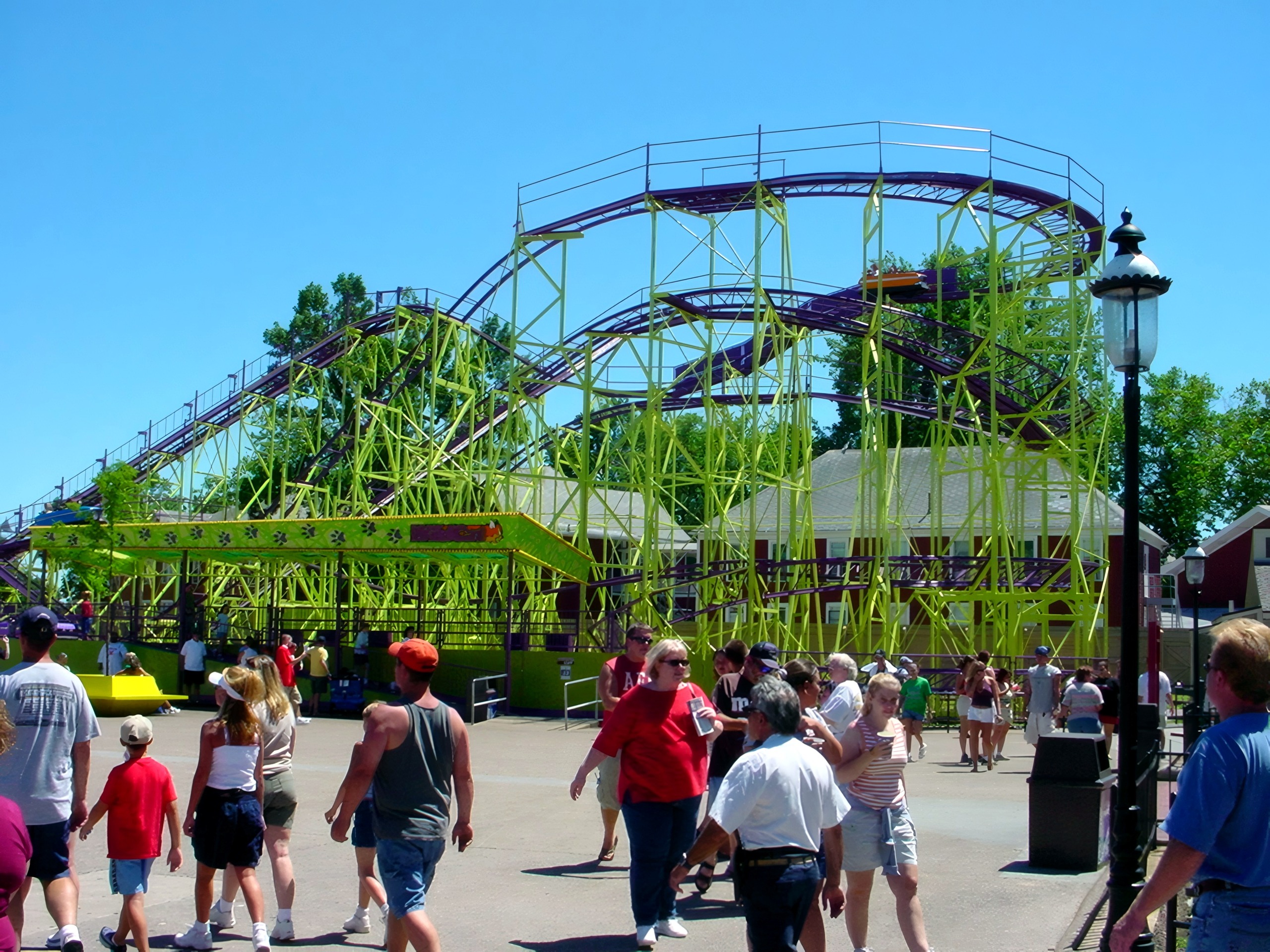 Green-framed purple-track coaster over midway, crowd below, July 16, 2003.