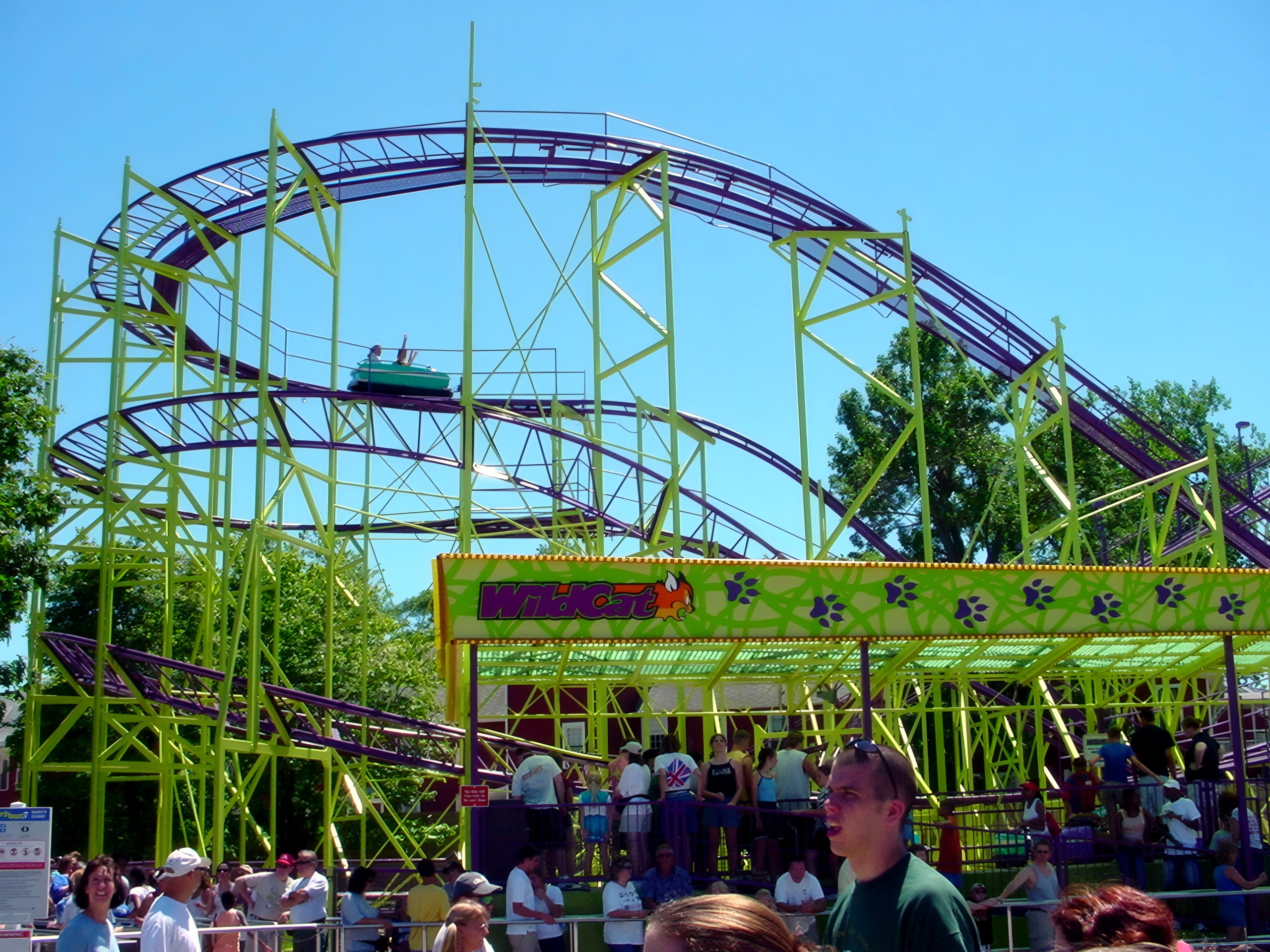 A WildCat car on the track above the station sign at Cedar Point, July 2003