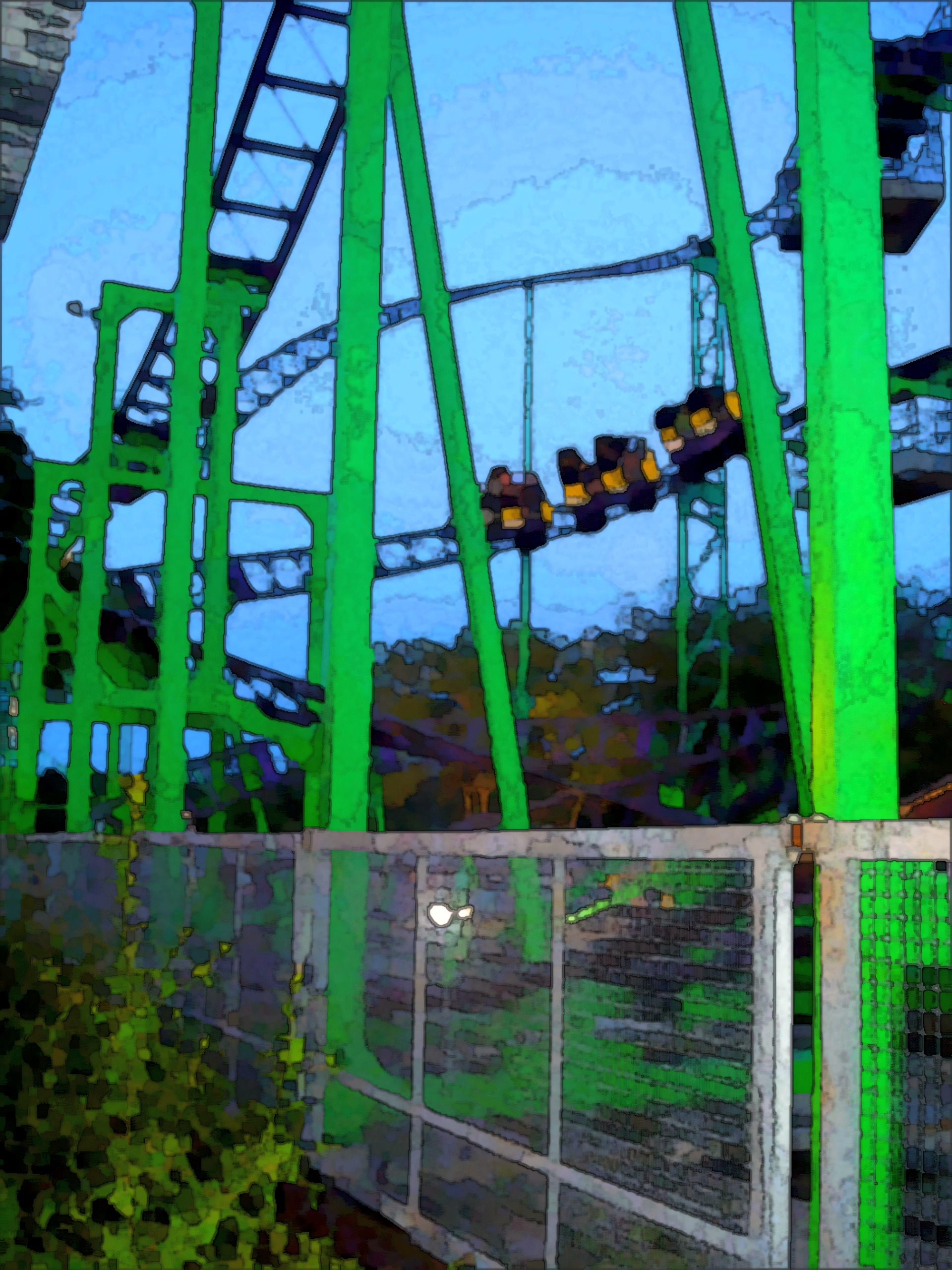 A Windstorm train on the track above the green supports at dusk at Old Town Kissimmee, July 2006