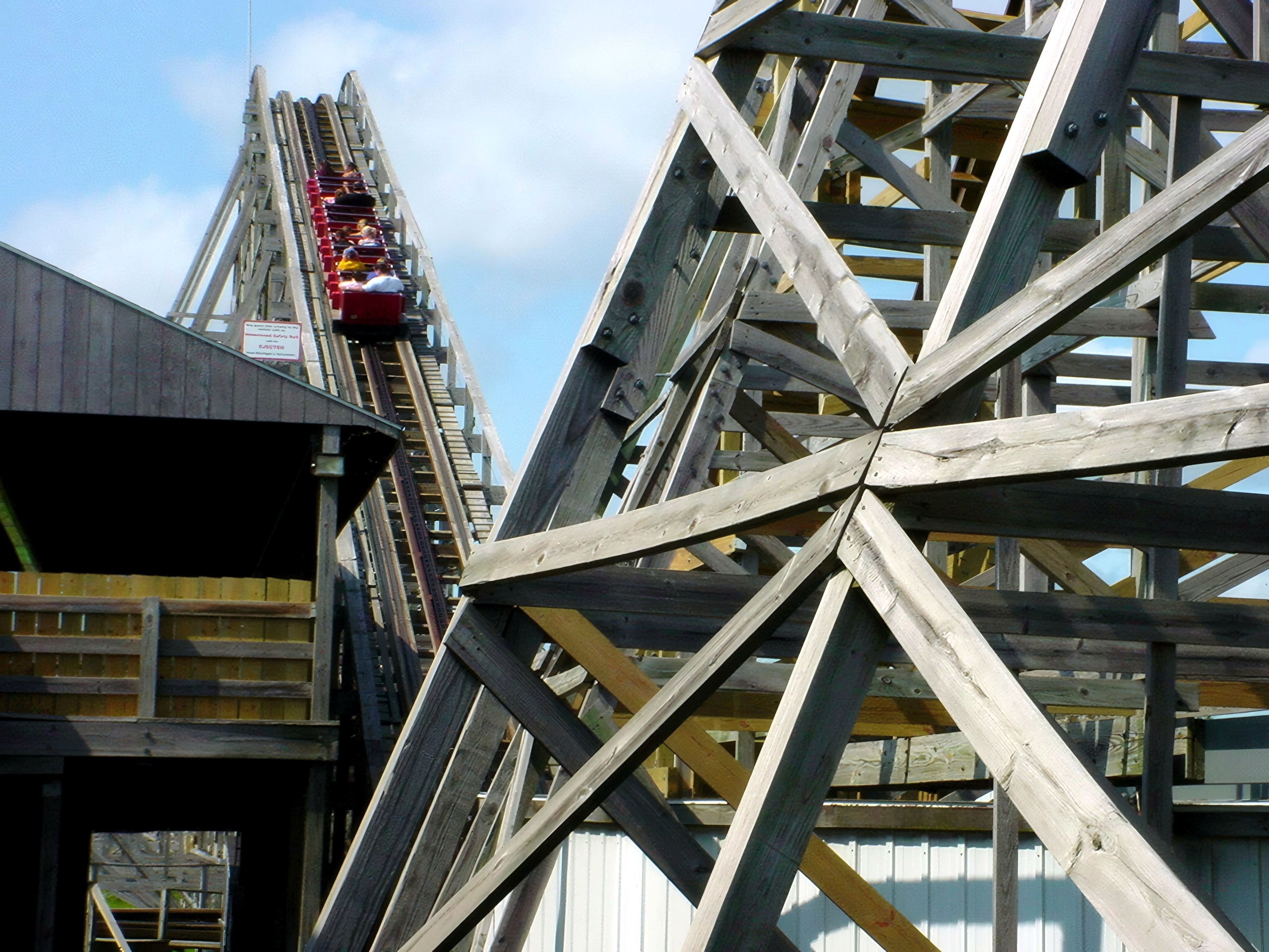 A Wolverine Wildcat train cresting the lift hill seen through the trestle, June 2002