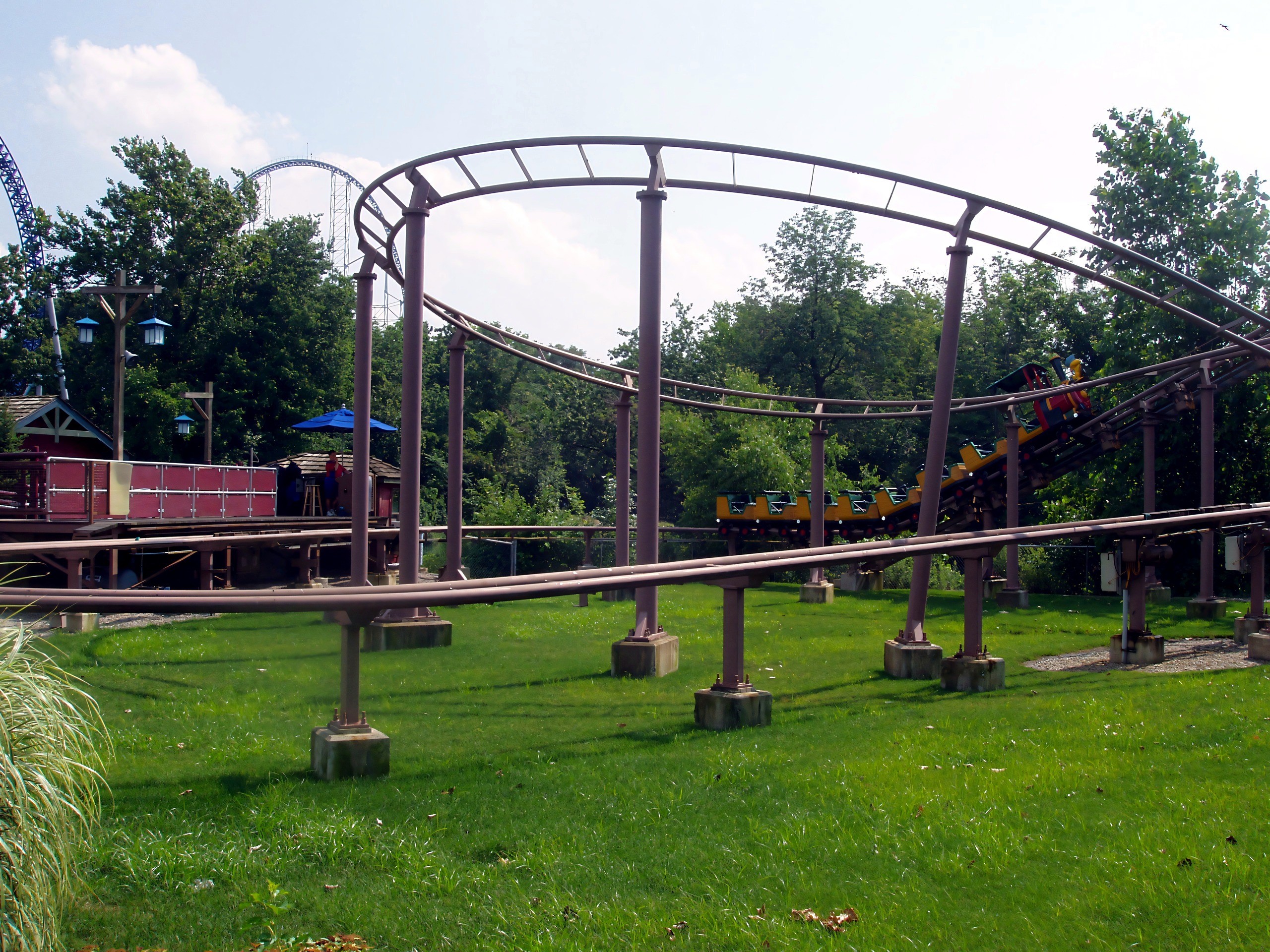 Coaster train on curved track, Millennium Force hill behind, Woodstock Express, July 2005
