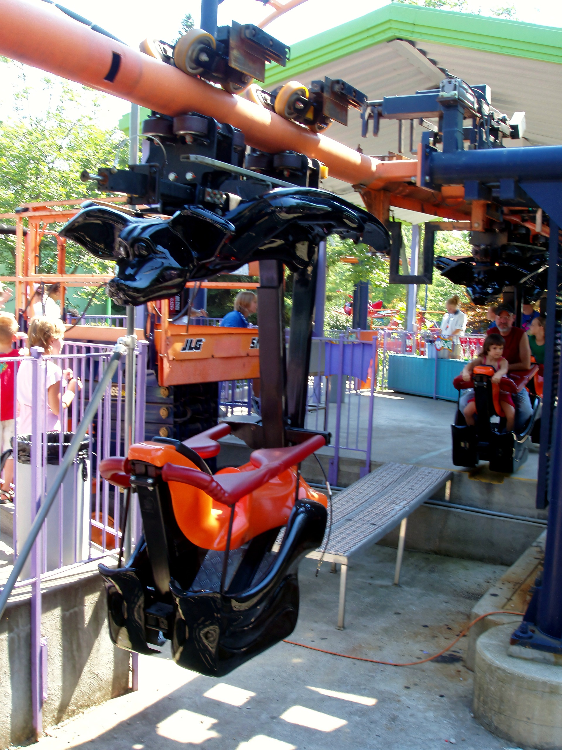 Suspended coaster trains with bat-wing seats parked in station, Woodstock Express, July 2005