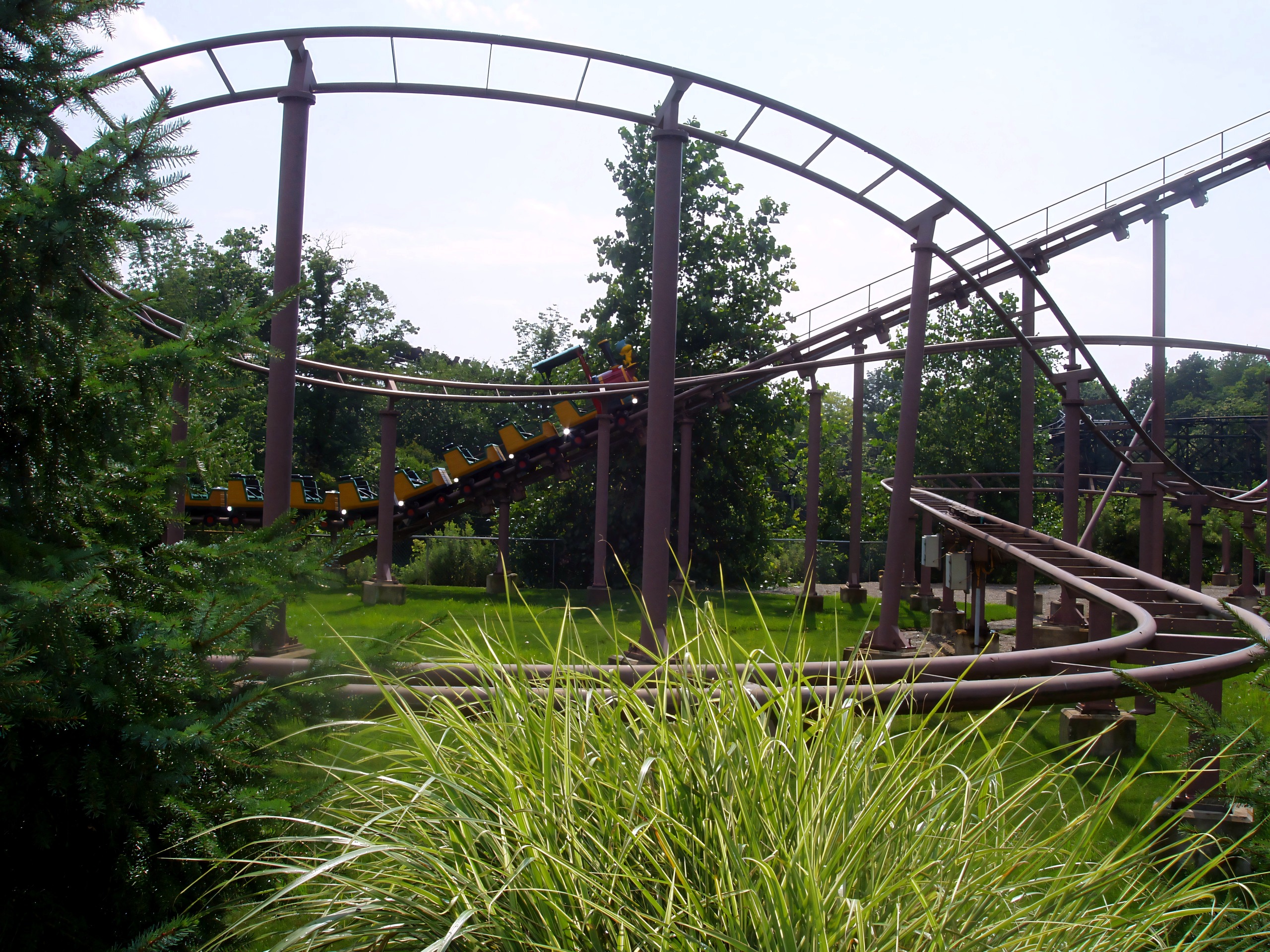 Yellow-trained steel family coaster winding through helix, Woodstock Express, July 2005