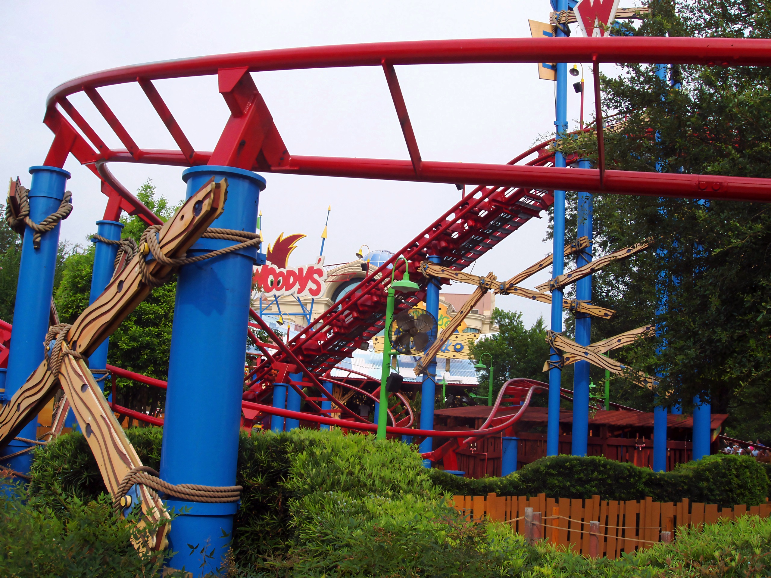 Woody Woodpecker's Nuthouse Coaster's red track and blue supports with the Woody sign behind at Universal Studios Florida, June 2006