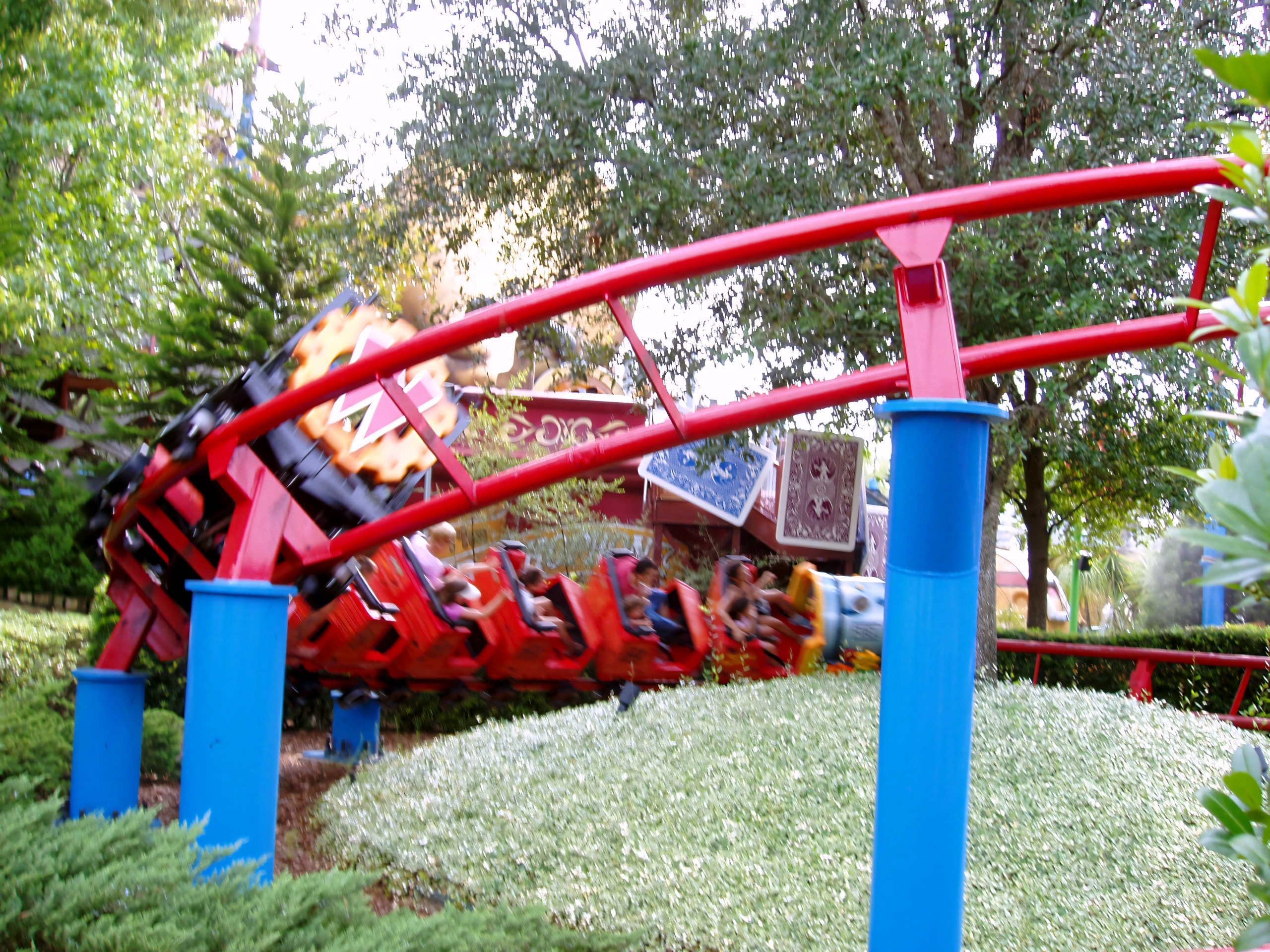 A Woody Woodpecker's Nuthouse Coaster train banking on the red track at Universal Studios Florida, June 2006