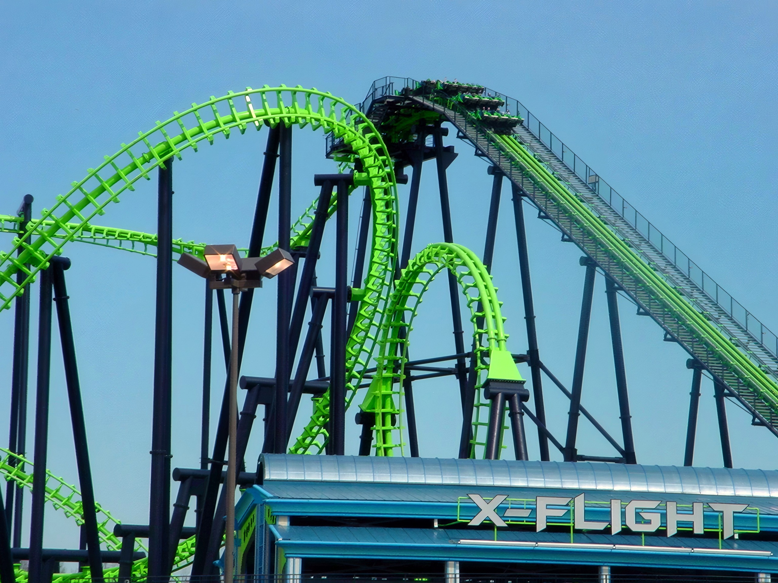 X-Flight's green track looping over the station sign, May 2002