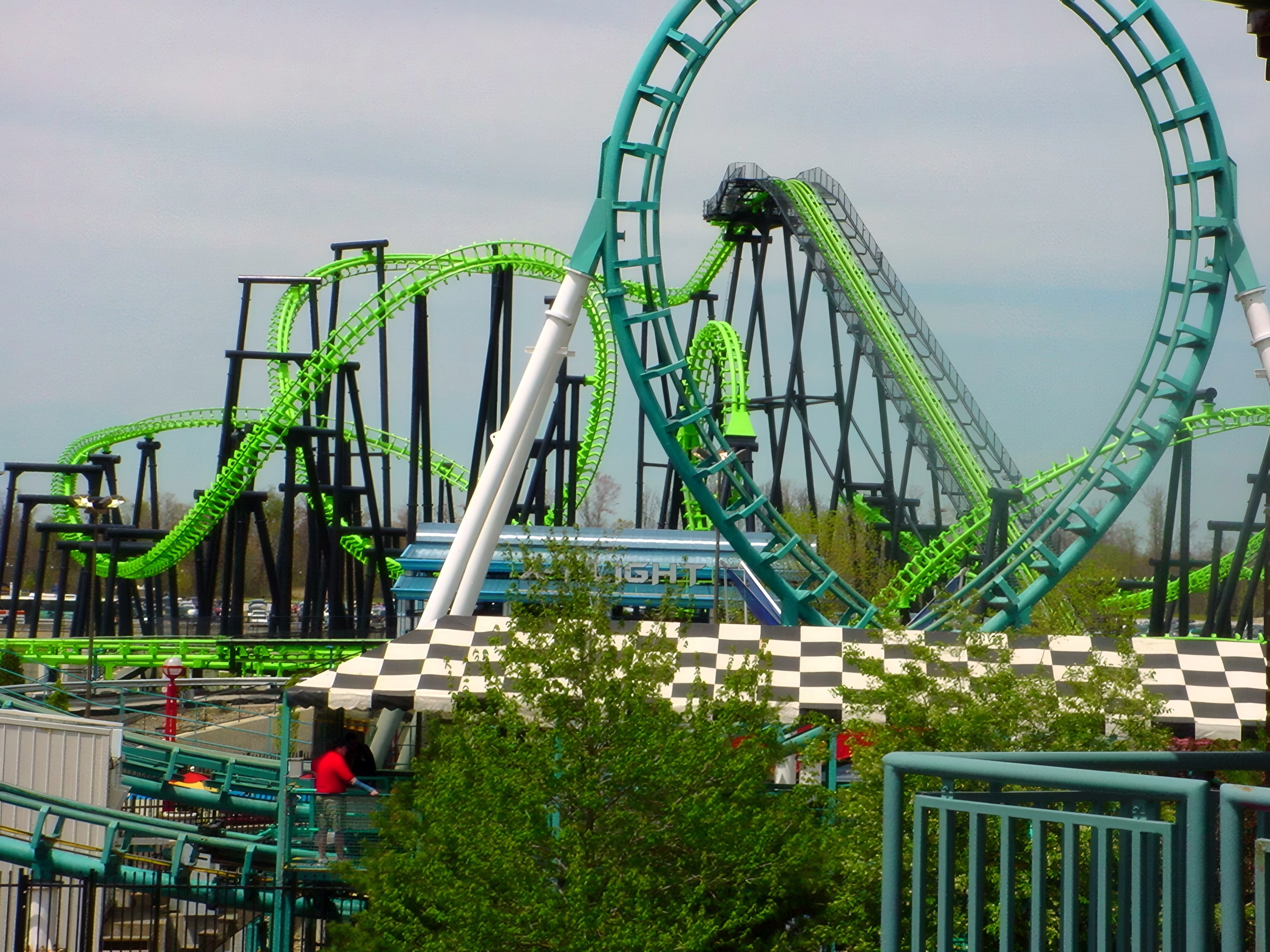 X-Flight's loops above the checkered entrance plaza, May 2002