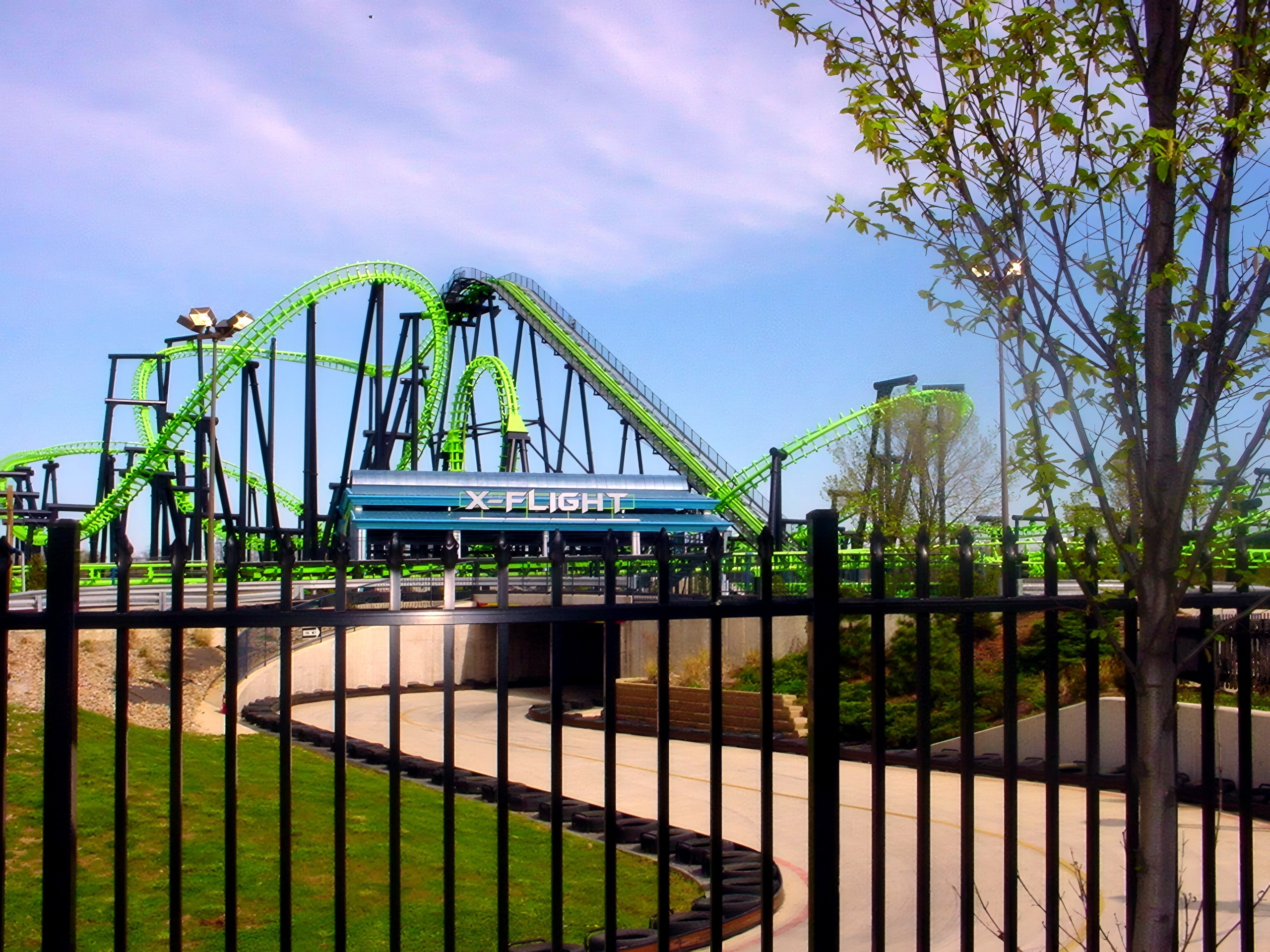 The X-Flight entrance sign and track behind the fence, May 2002