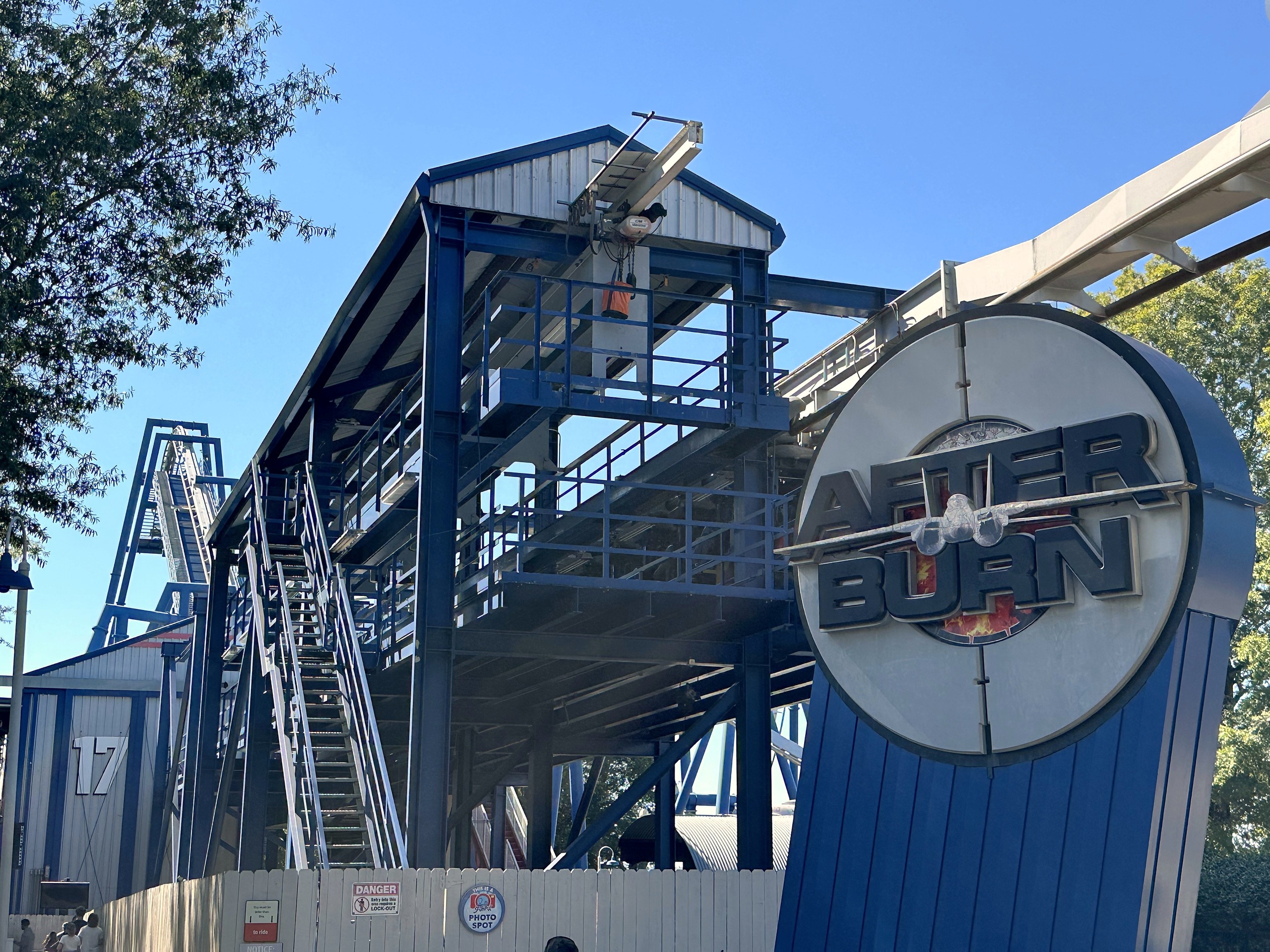 The Afterburn entrance sign in front of the blue steel station and lift structure at Carowinds, October 2024