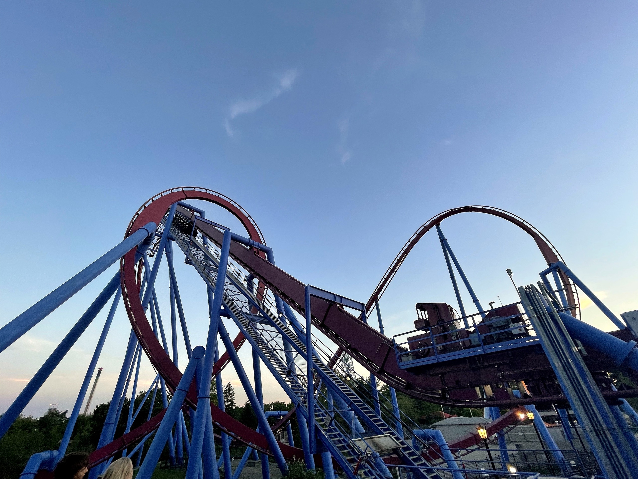 A wider view of Banshee's loop and lift hill against the evening sky, Kings Island, July 2022