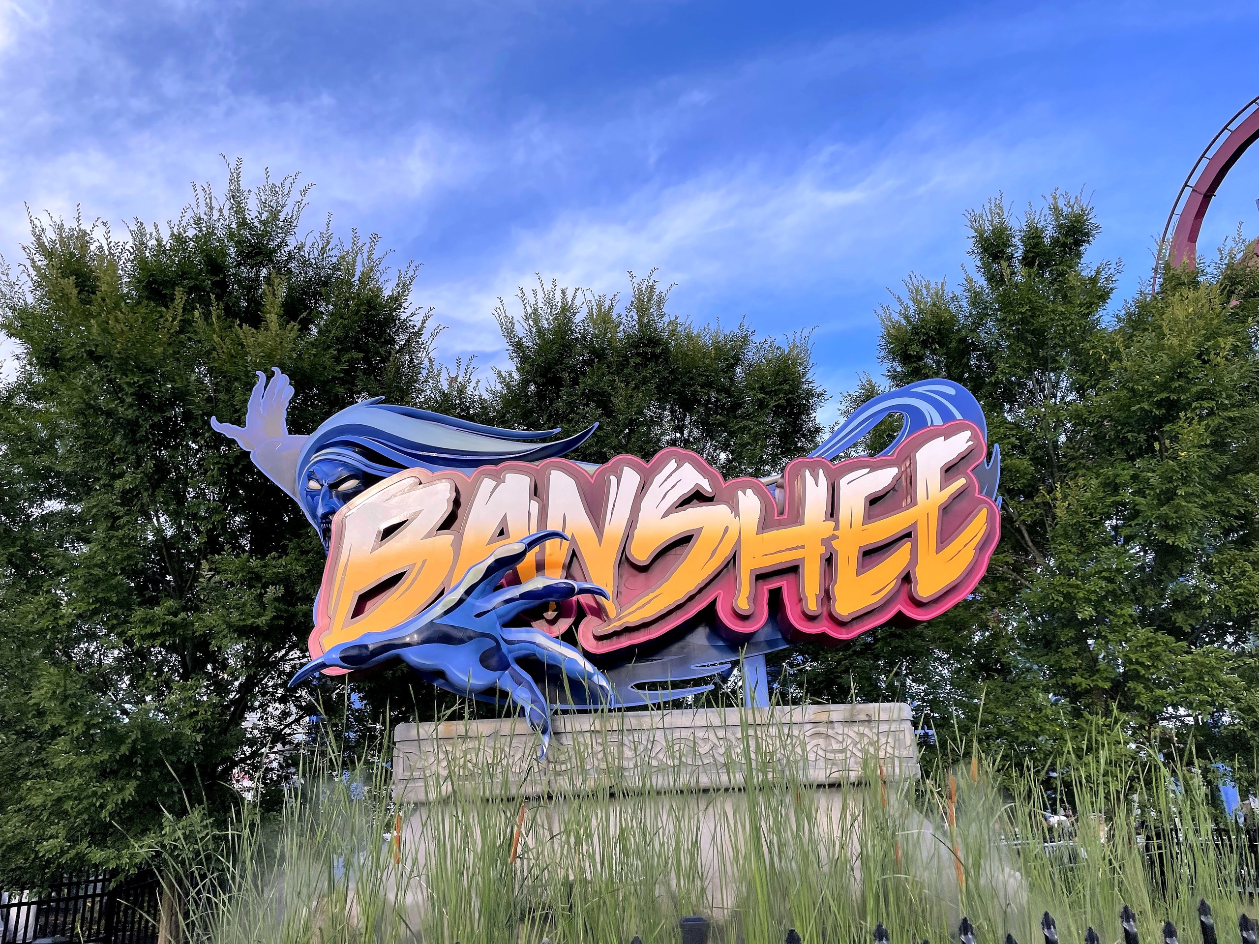 The Banshee sign from the path with the track at the top right, Kings Island, July 2022