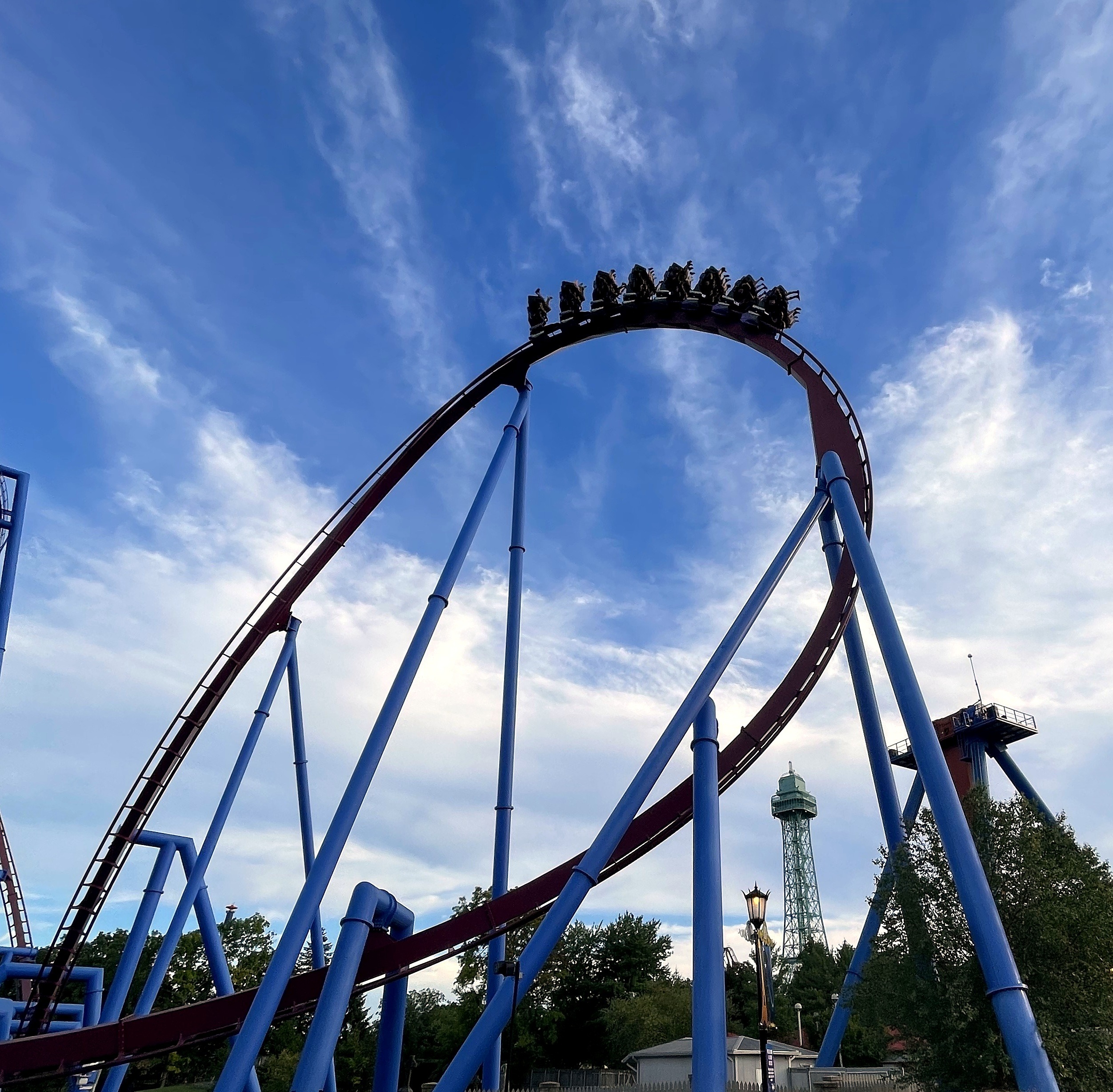 A Banshee train at the top of the track with the Eiffel Tower behind the supports, Kings Island, July 2022