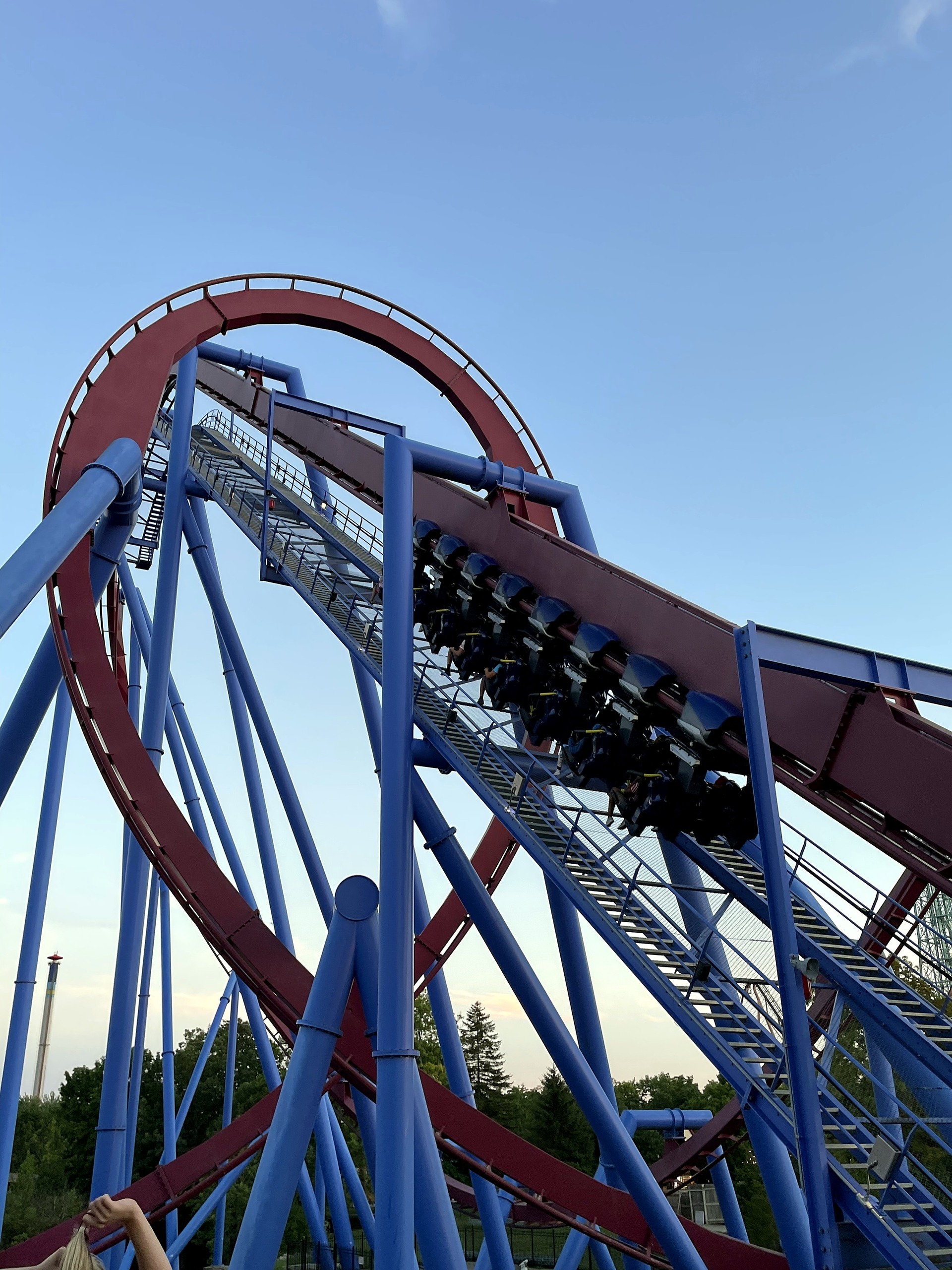 A Banshee train climbing the lift hill inside the maroon loop, Kings Island, July 2022