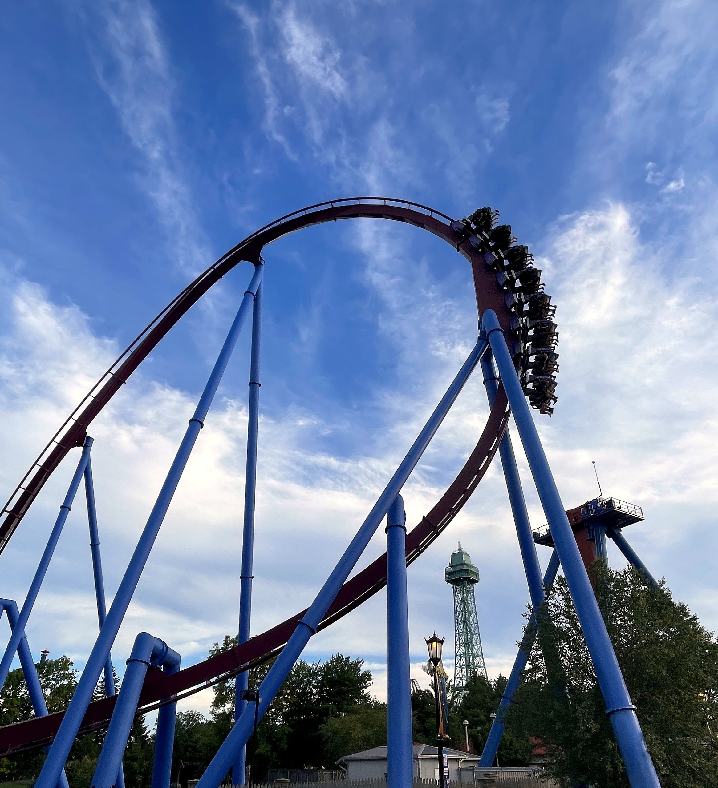 A Banshee train dropping off the top of the curve with the Eiffel Tower in the distance, Kings Island, July 2022