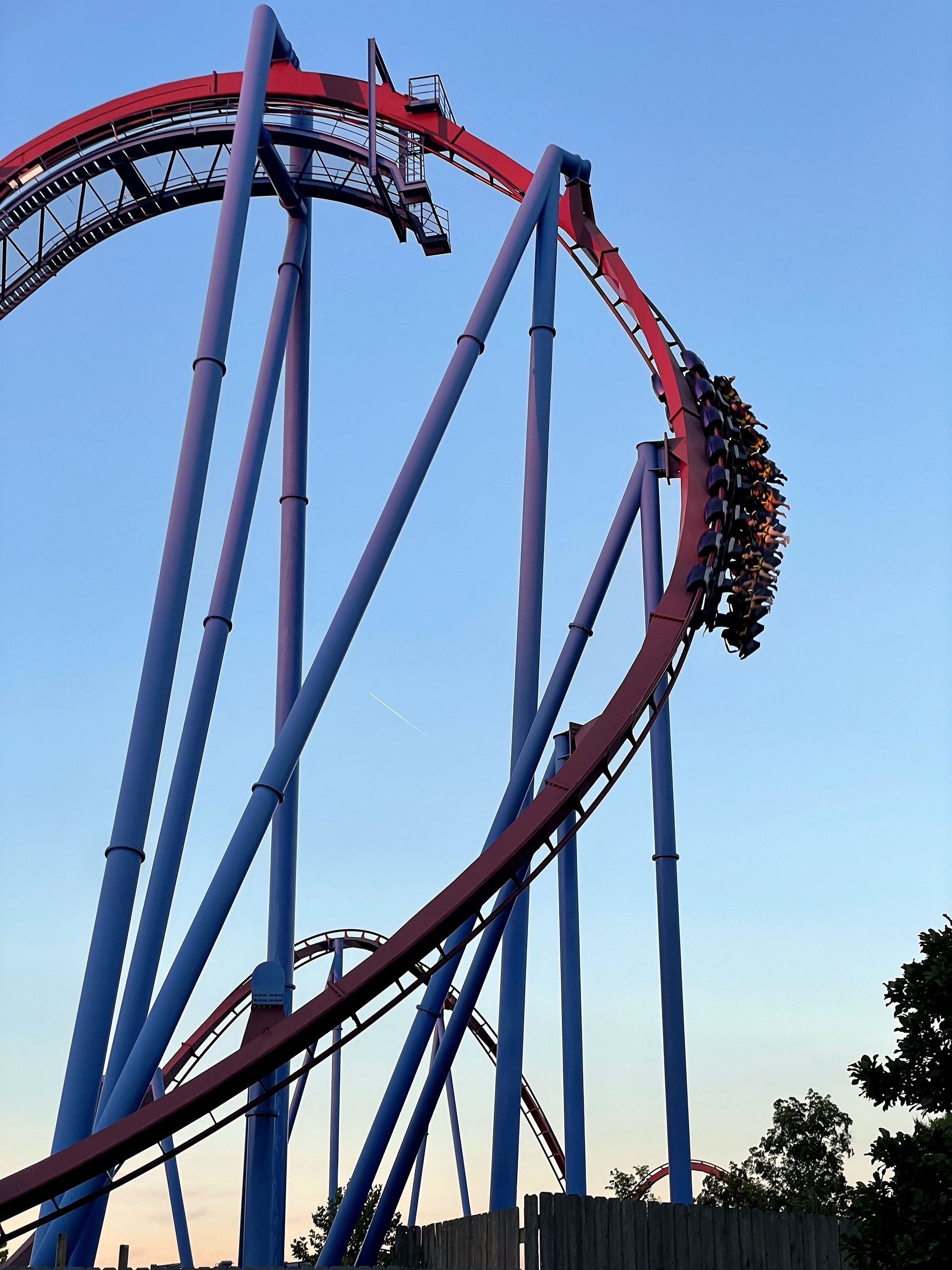 A Banshee train with riders' legs dangling on the outside of the big curve, Kings Island, July 2022