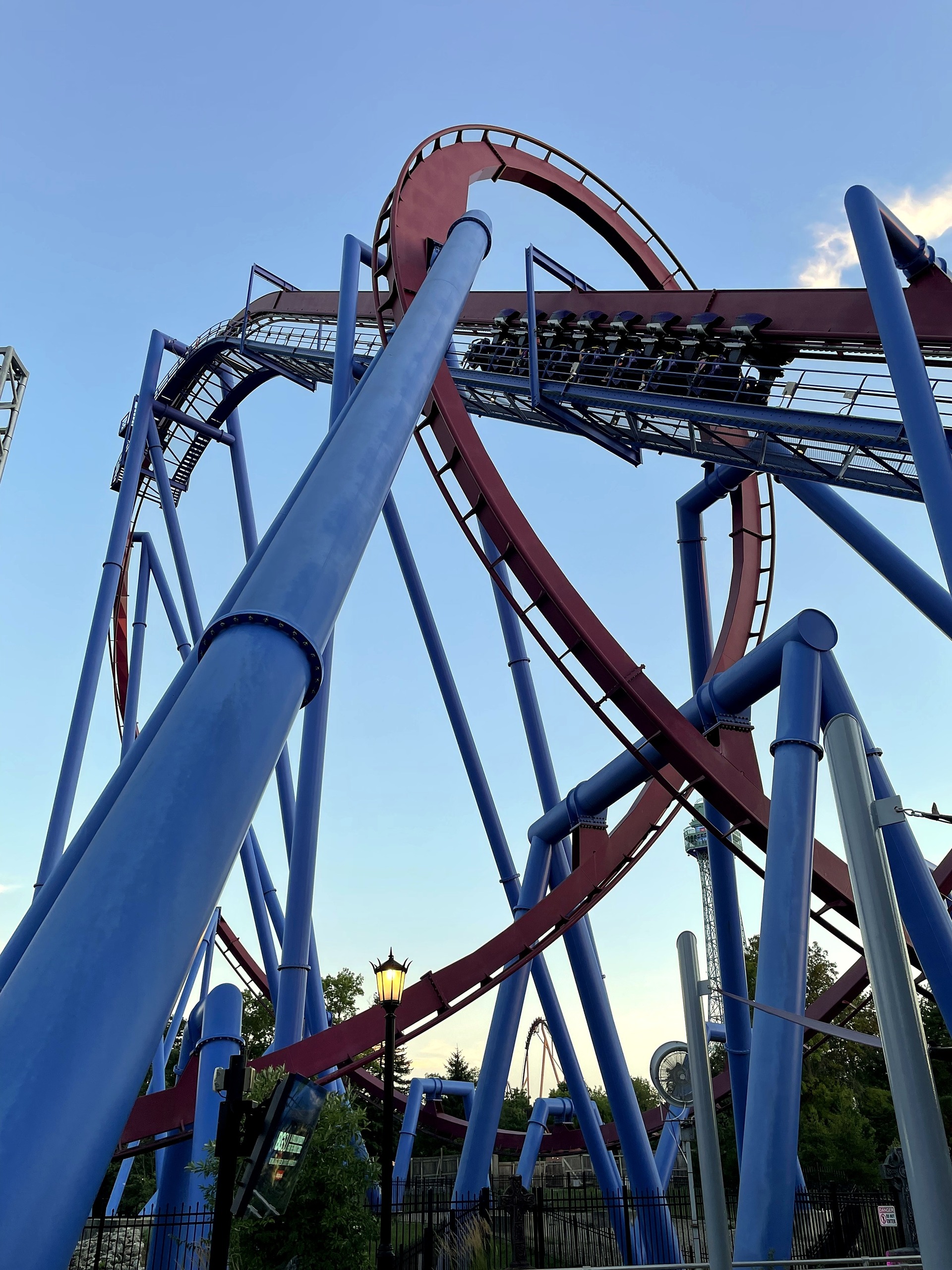 A Banshee train higher on the lift hill, seen from below the loop, Kings Island, July 2022