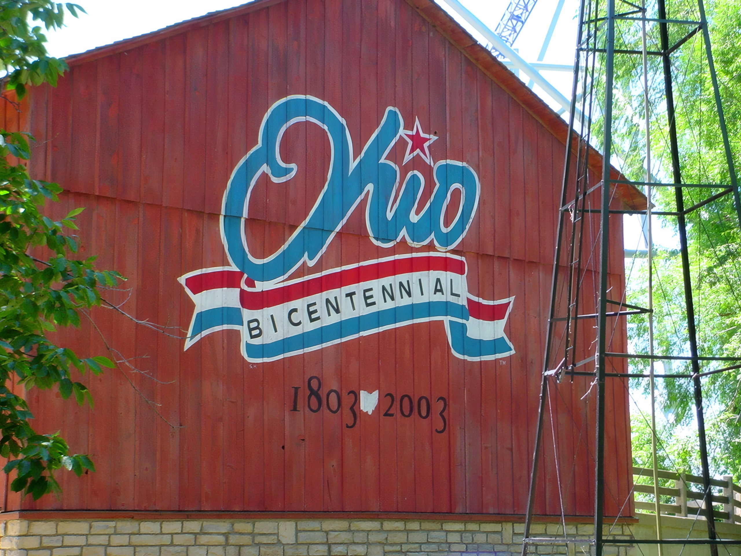 The Ohio Bicentennial mural on a red barn with coaster structure behind at Cedar Point, July 2003