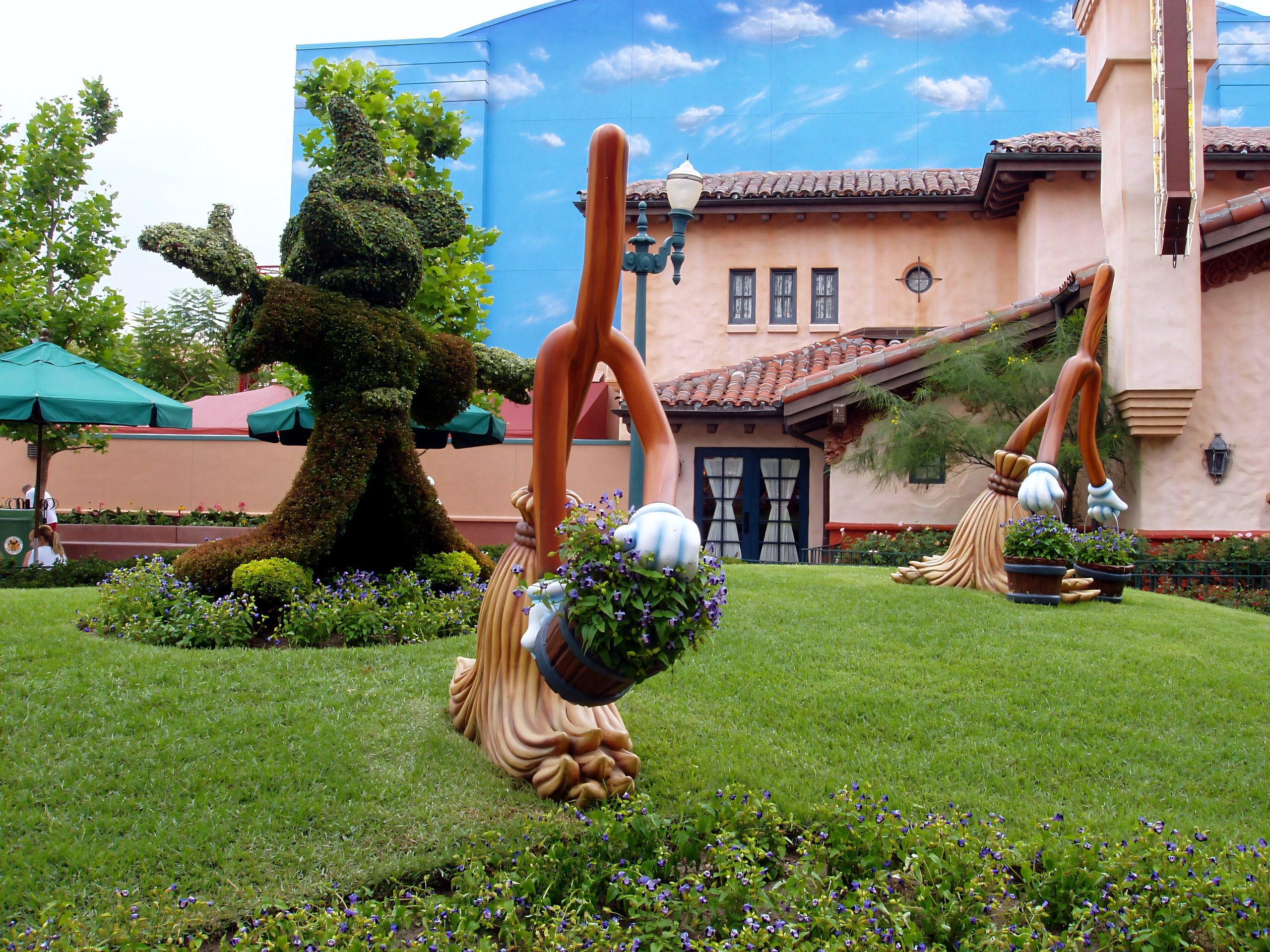 Sorcerer Mickey topiary with brooms near Hollywood Studios entrance building, Disney's Hollywood Studios, June 2006