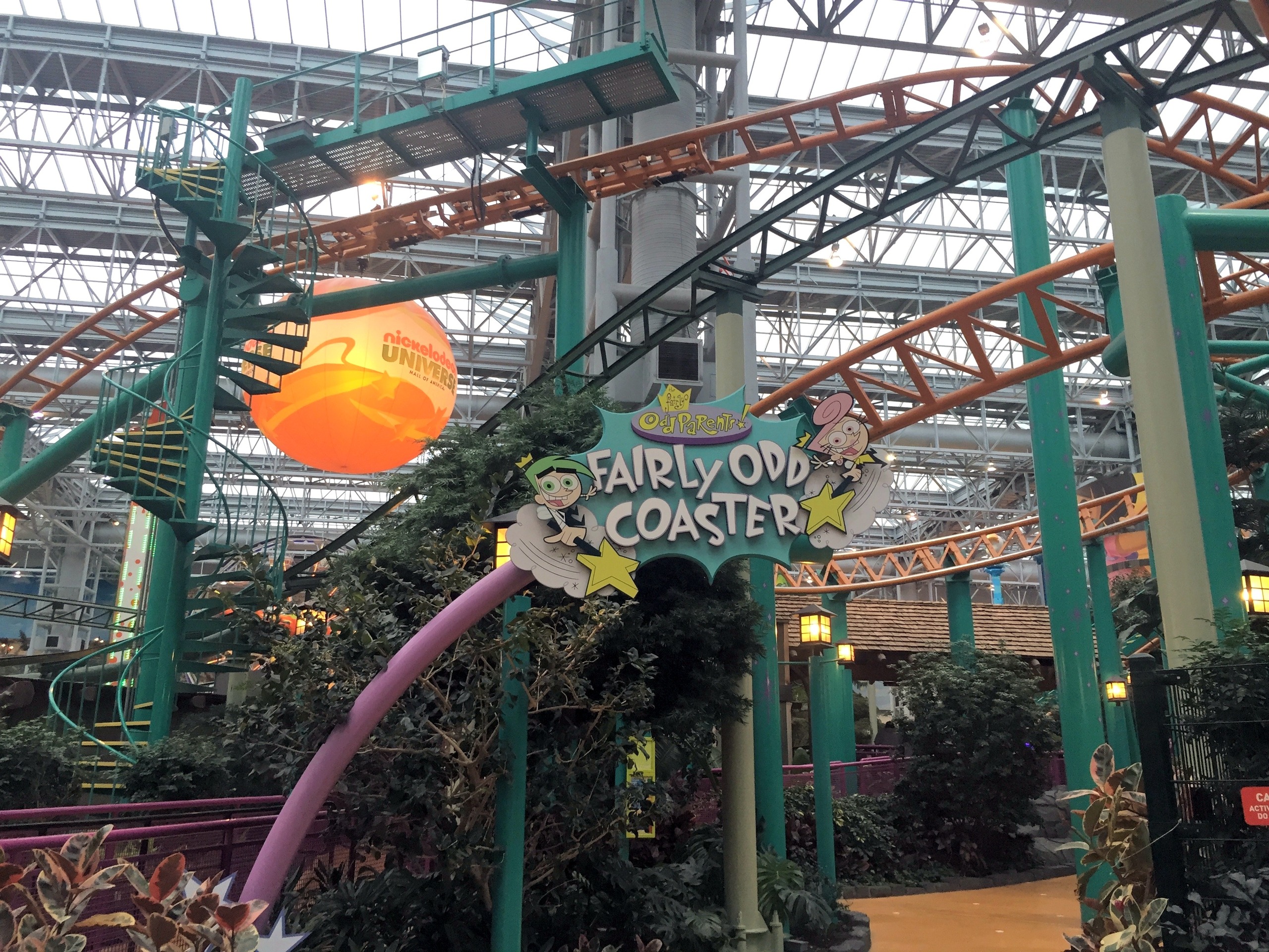 The sign with the orange spinning-coaster track and spiral stairs behind it, Nickelodeon Universe, Mall of America, November 2015