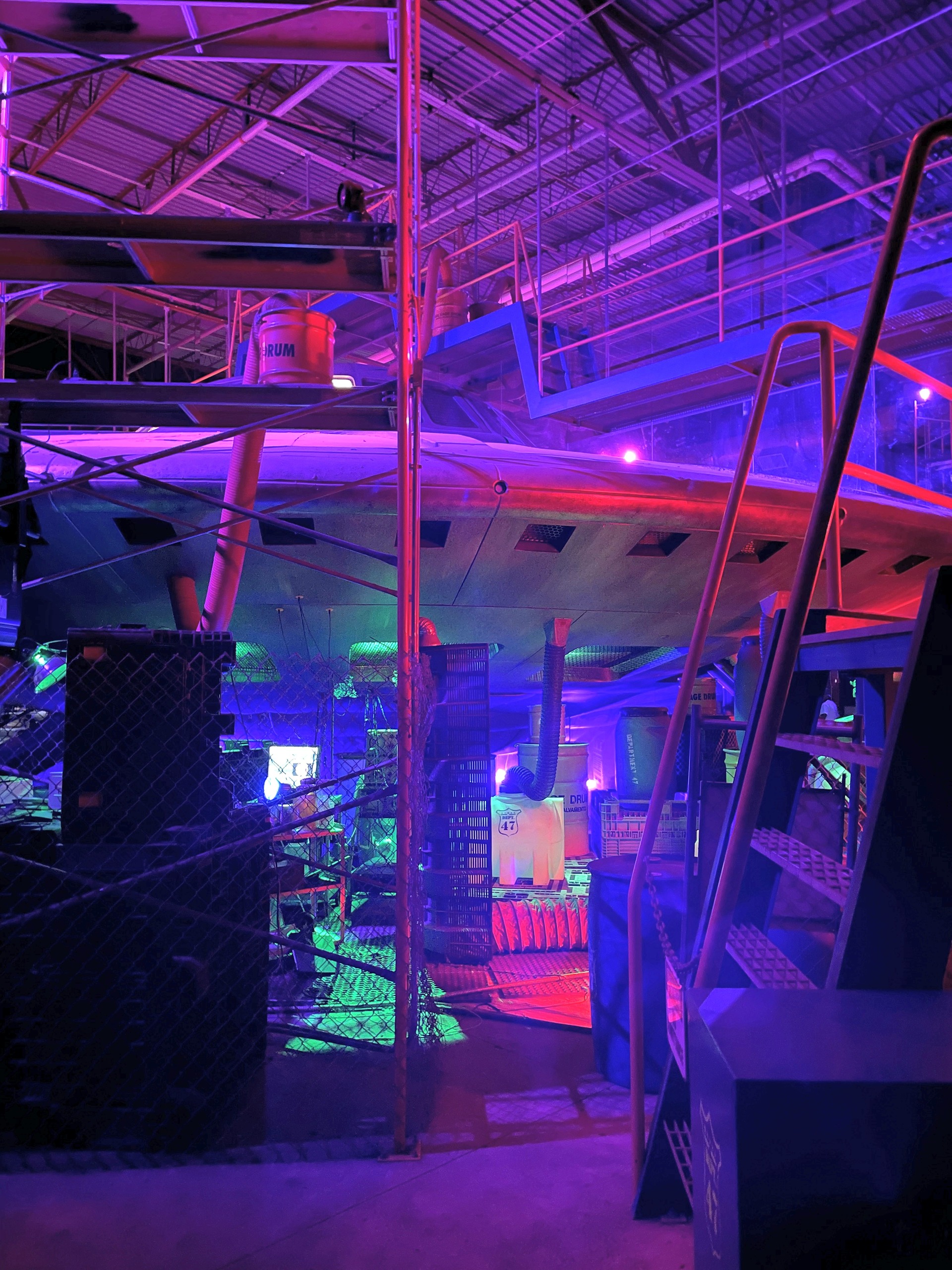 Under the rim of the flying saucer in purple and blue light, Kings Island, July 2022