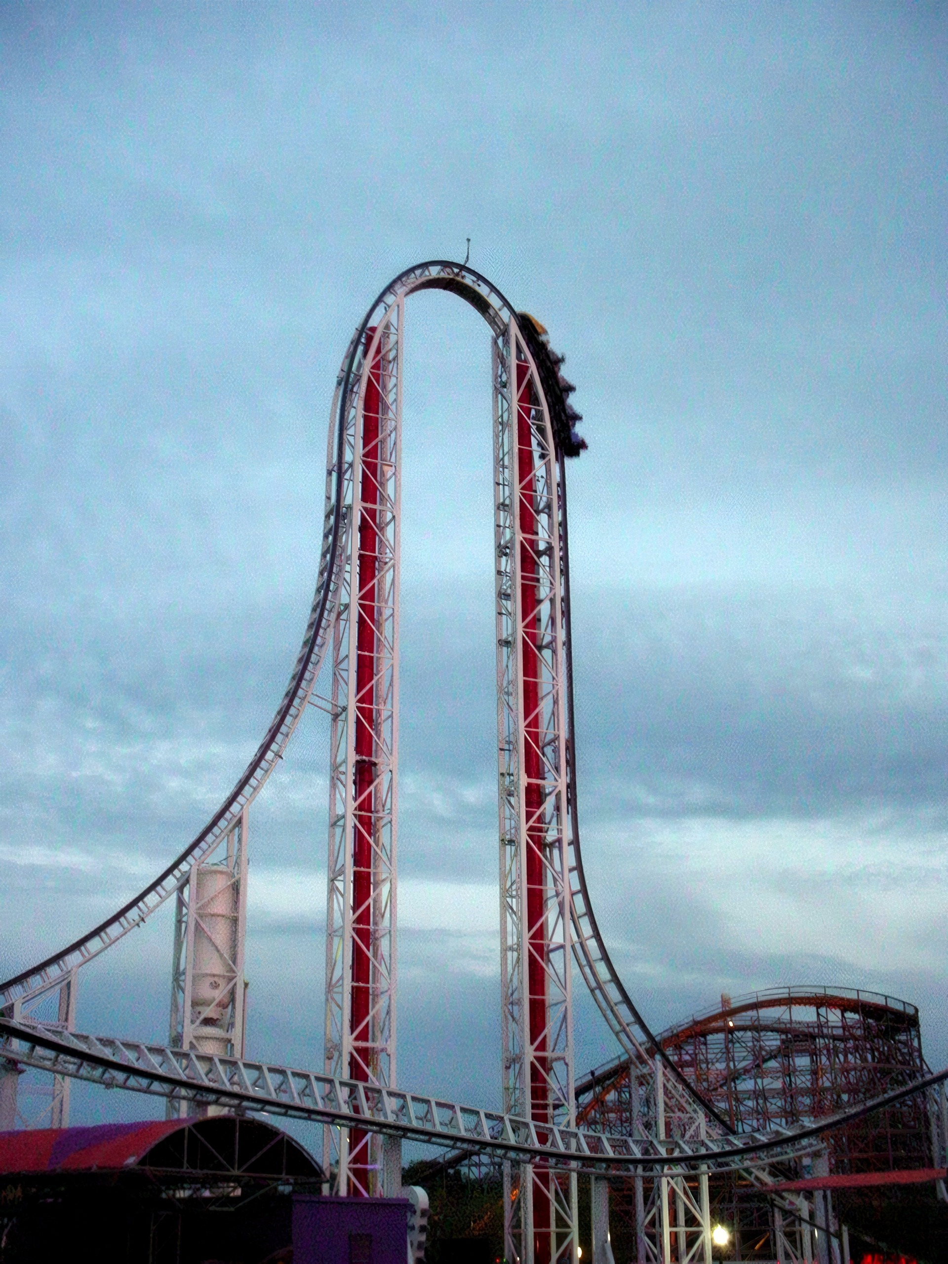 A Hypersonic XLC train on the top hat under a cloudy dusk sky at Kings Dominion, July 2001