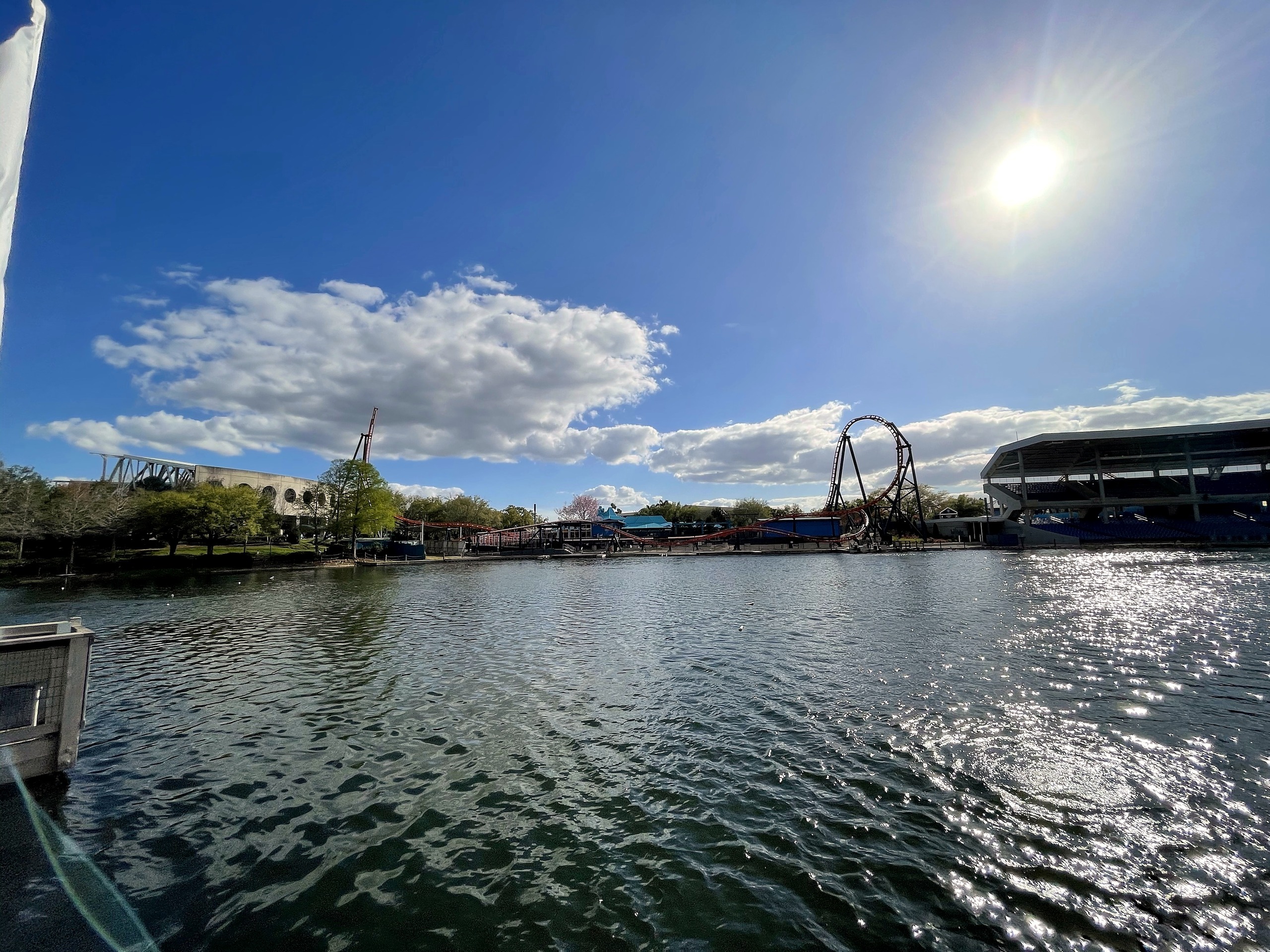 Ice Breaker's top hat across the sunlit lake at SeaWorld Orlando, March 2021