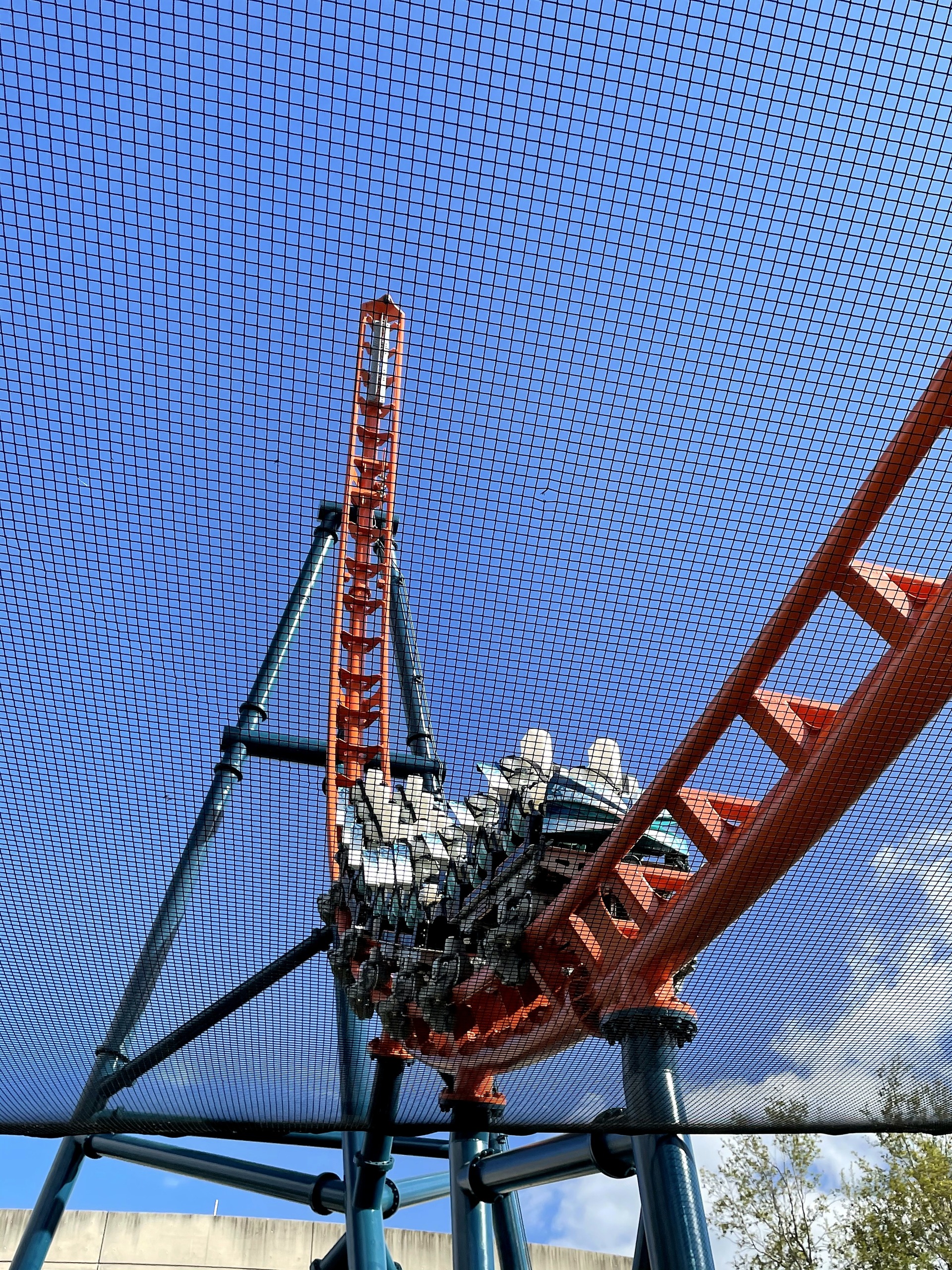 An Ice Breaker train at the base of the spike, seen through the safety netting at SeaWorld Orlando, March 2021