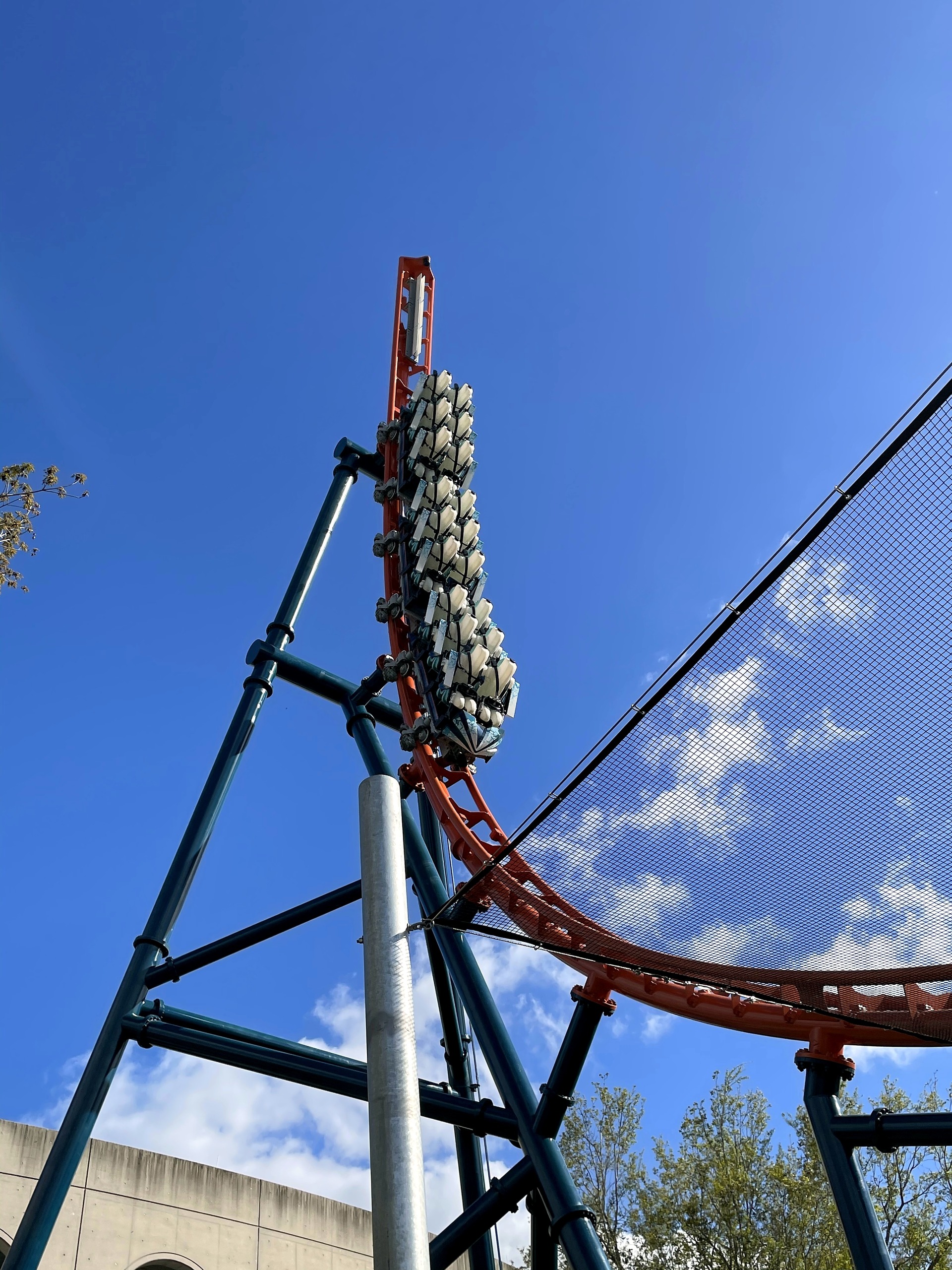 An Ice Breaker train on the spike above the teal supports at SeaWorld Orlando, March 2021