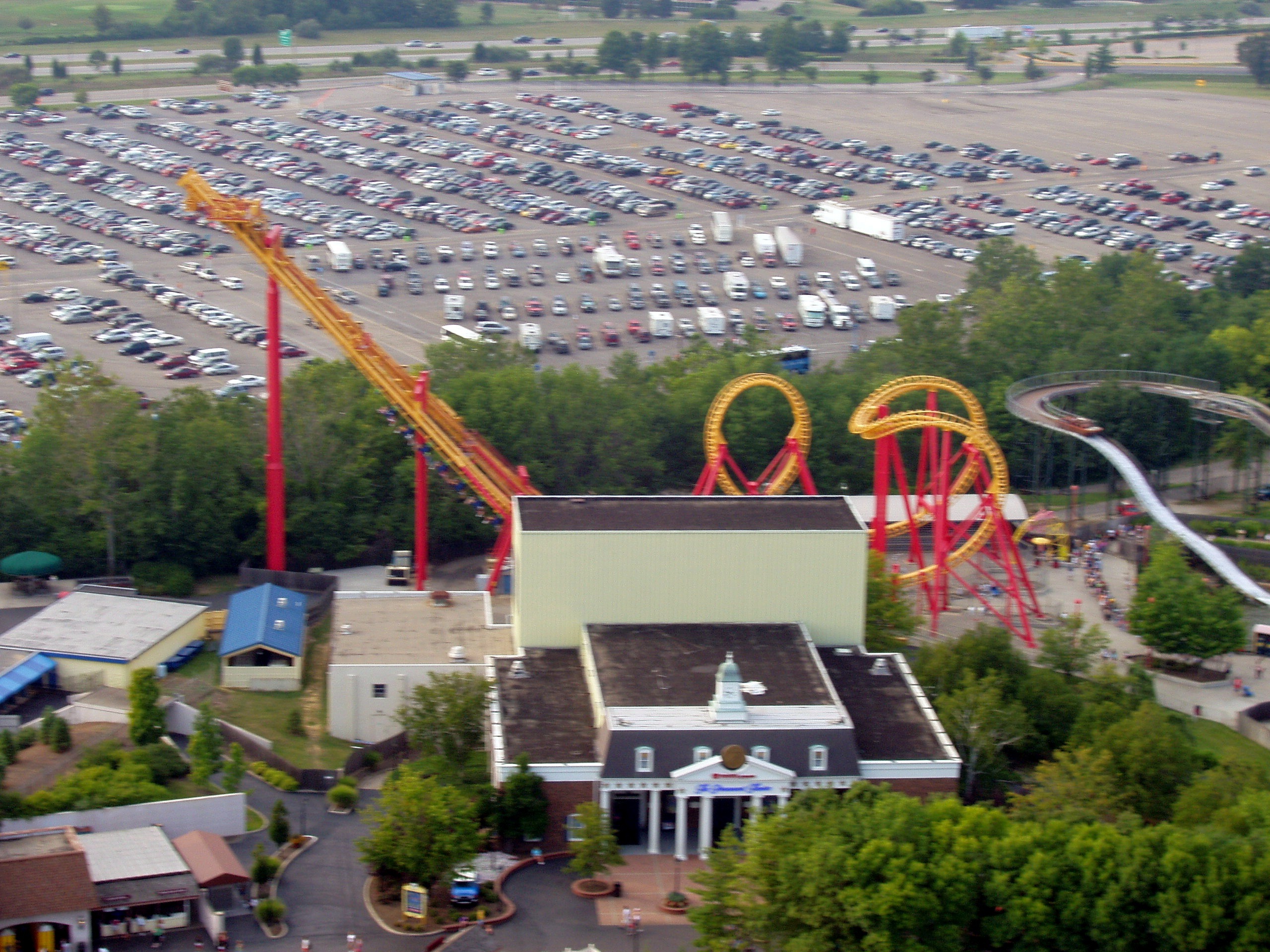 Face/Off's red and yellow track beyond the parking lot, seen from the Eiffel Tower at Paramount's Kings Island, August 2006