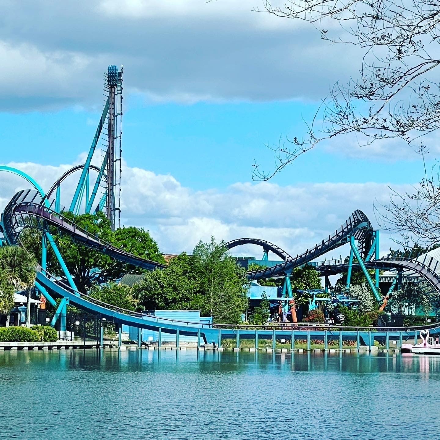 Mako's lift hill and dark track curving along the lake with Kraken's loop at left at SeaWorld Orlando, March 2021