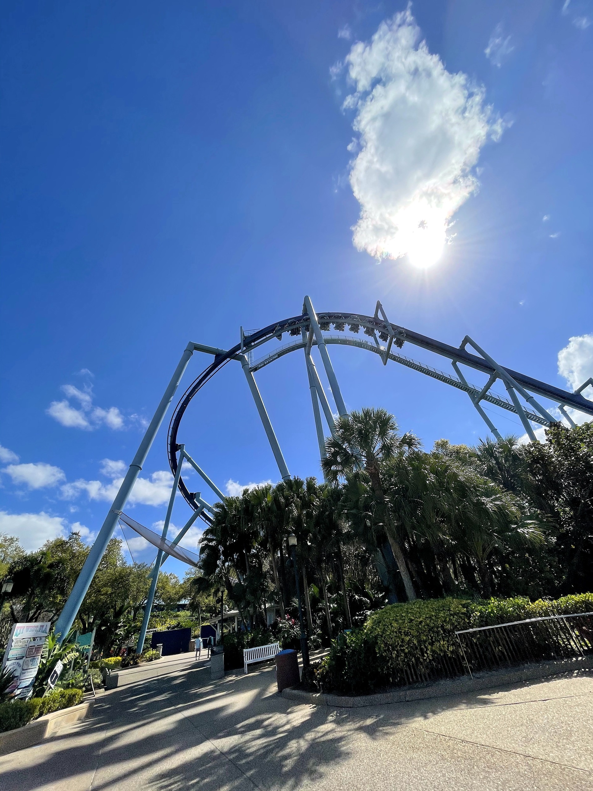 Manta's loop above the walkway with the sun behind a cloud at SeaWorld Orlando, March 2021