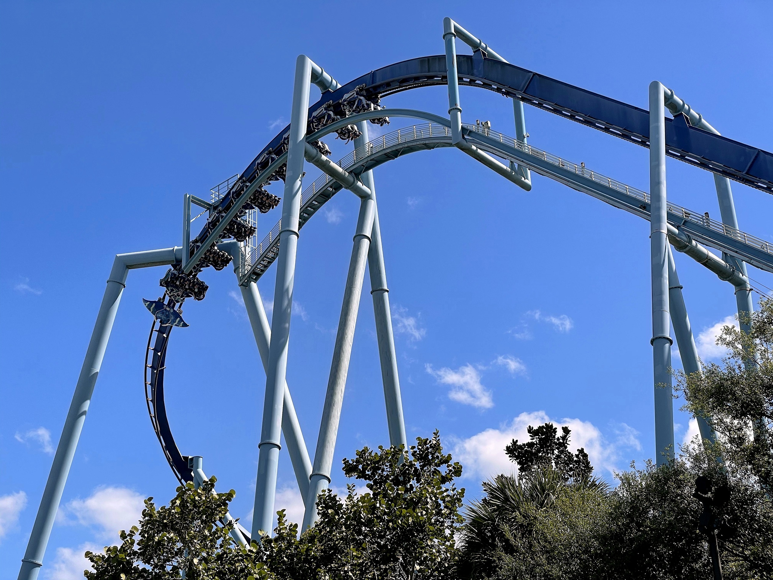 A Manta train passing through the loop against a blue sky at SeaWorld Orlando, March 2021