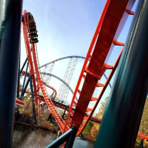 A Mantis train at the top of the loop in Rougarou's orange and teal, framed by supports over the lagoon at Cedar Point, October 2014