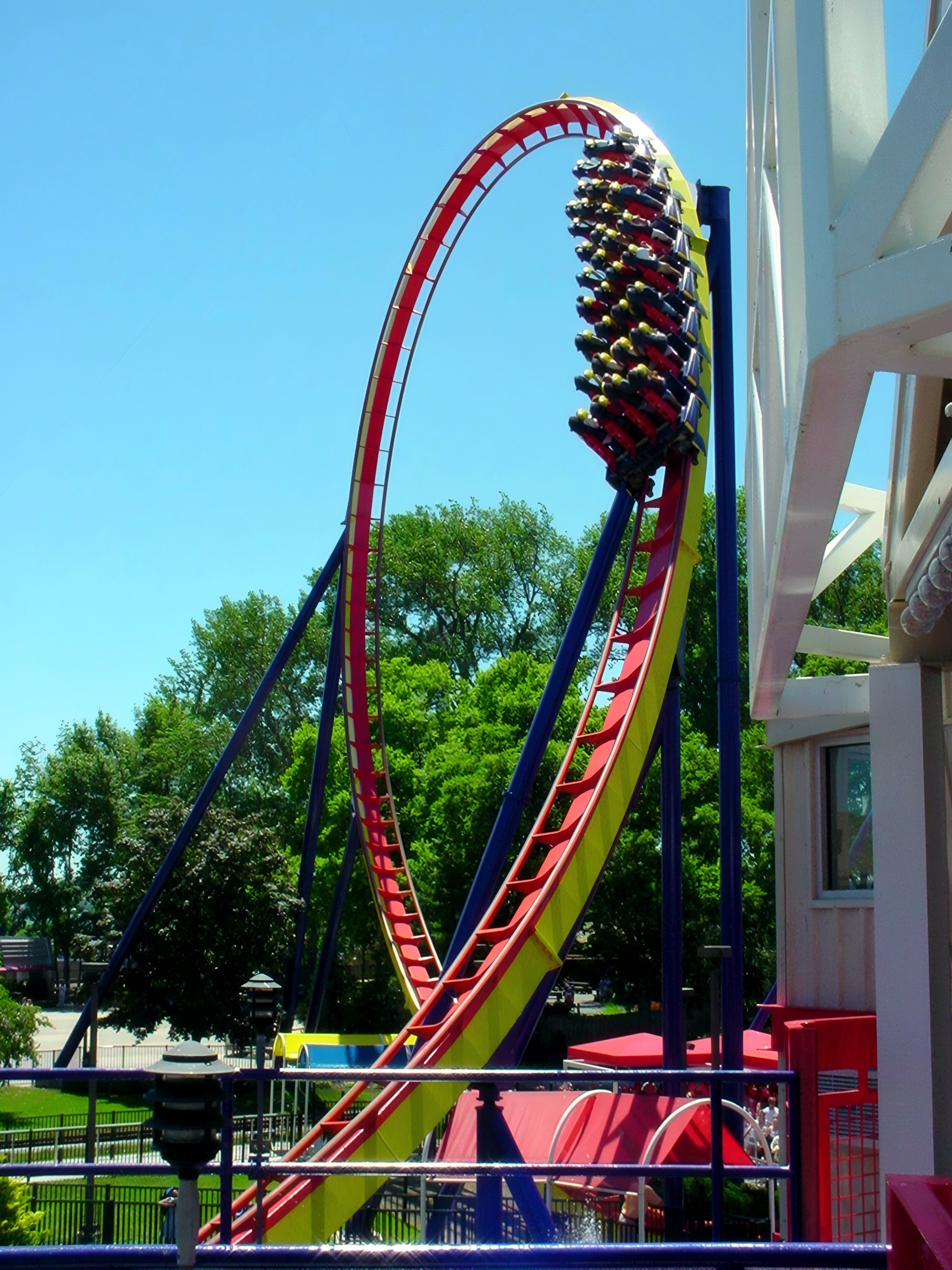 Mantis vertical loop with train, blue sky, Mantis at Cedar Point