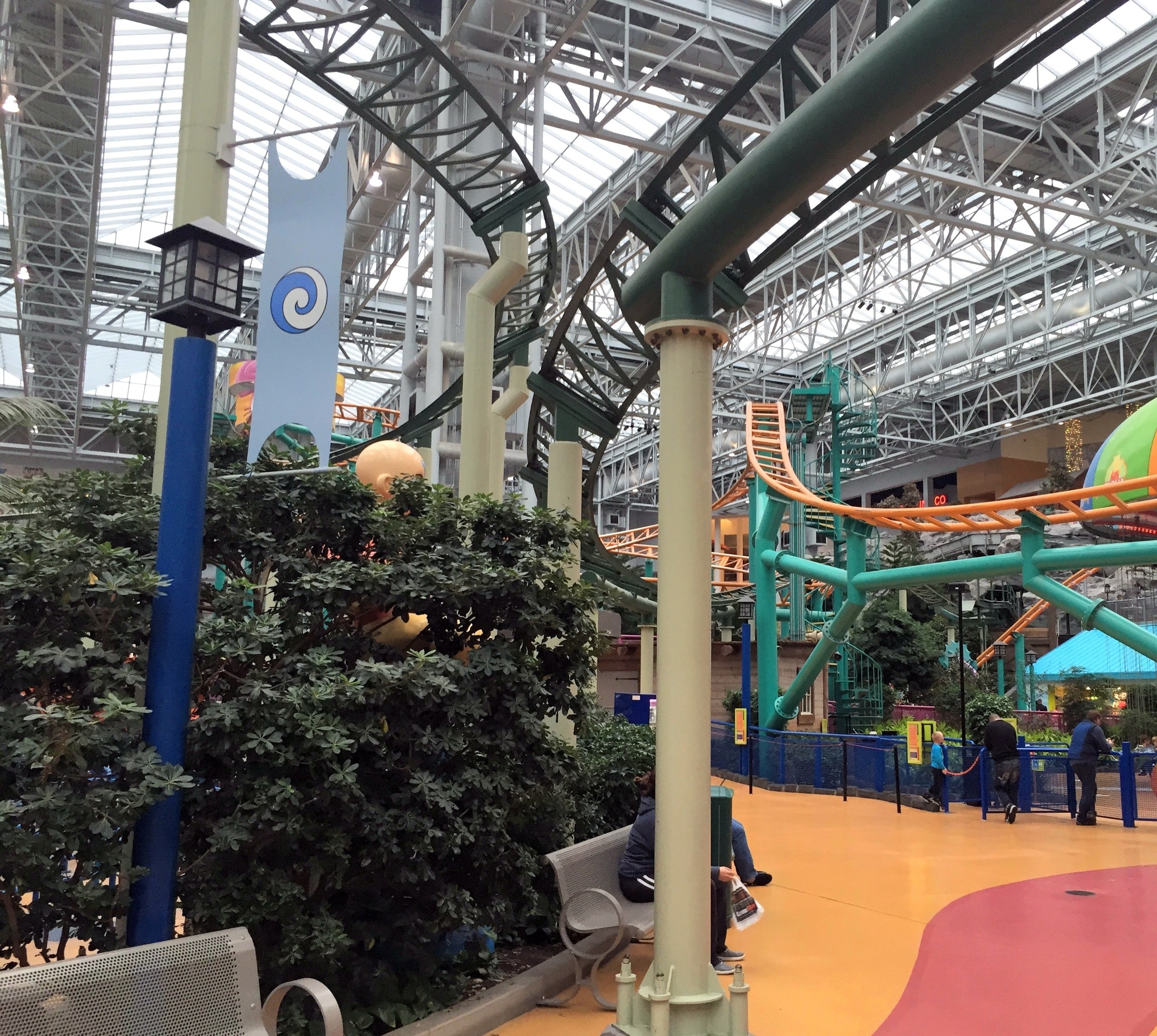 Pepsi Orange Streak's orange track curving over the walkway on green supports, Nickelodeon Universe, Mall of America, November 2015